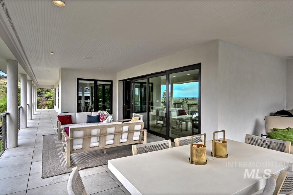 Expansive covered patio featuring large format tile flooring and recessed lighting