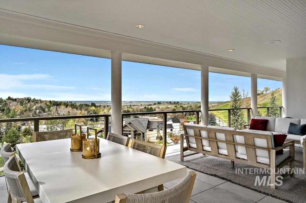 Spacious covered patio featuring a slatted ceiling, recessed lighting, and tile flooring