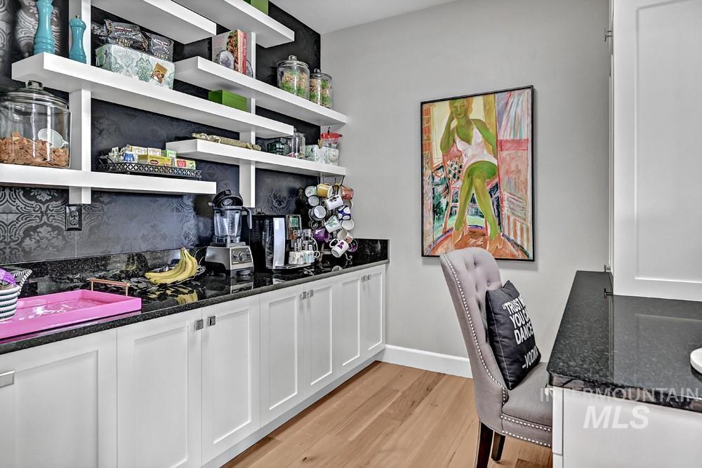 Built-in cabinetry with white shaker-style doors and dark countertops