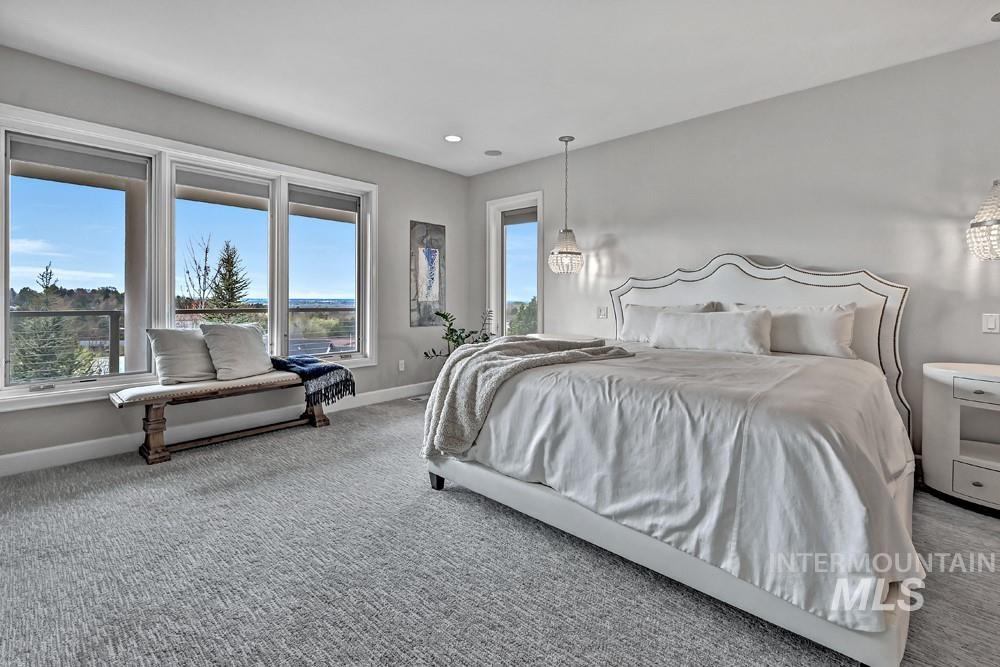 Spacious room featuring a wall of multiple windows, recessed lighting, and light-toned textured carpeting