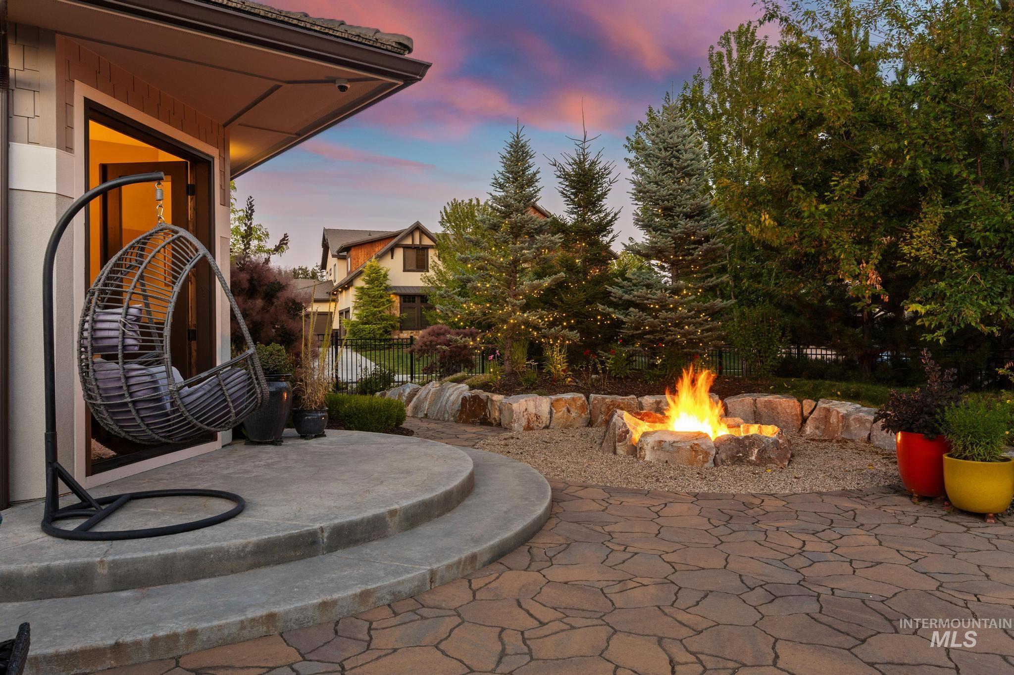 Patio terrace at dusk with an outdoor fire pit and a patio area