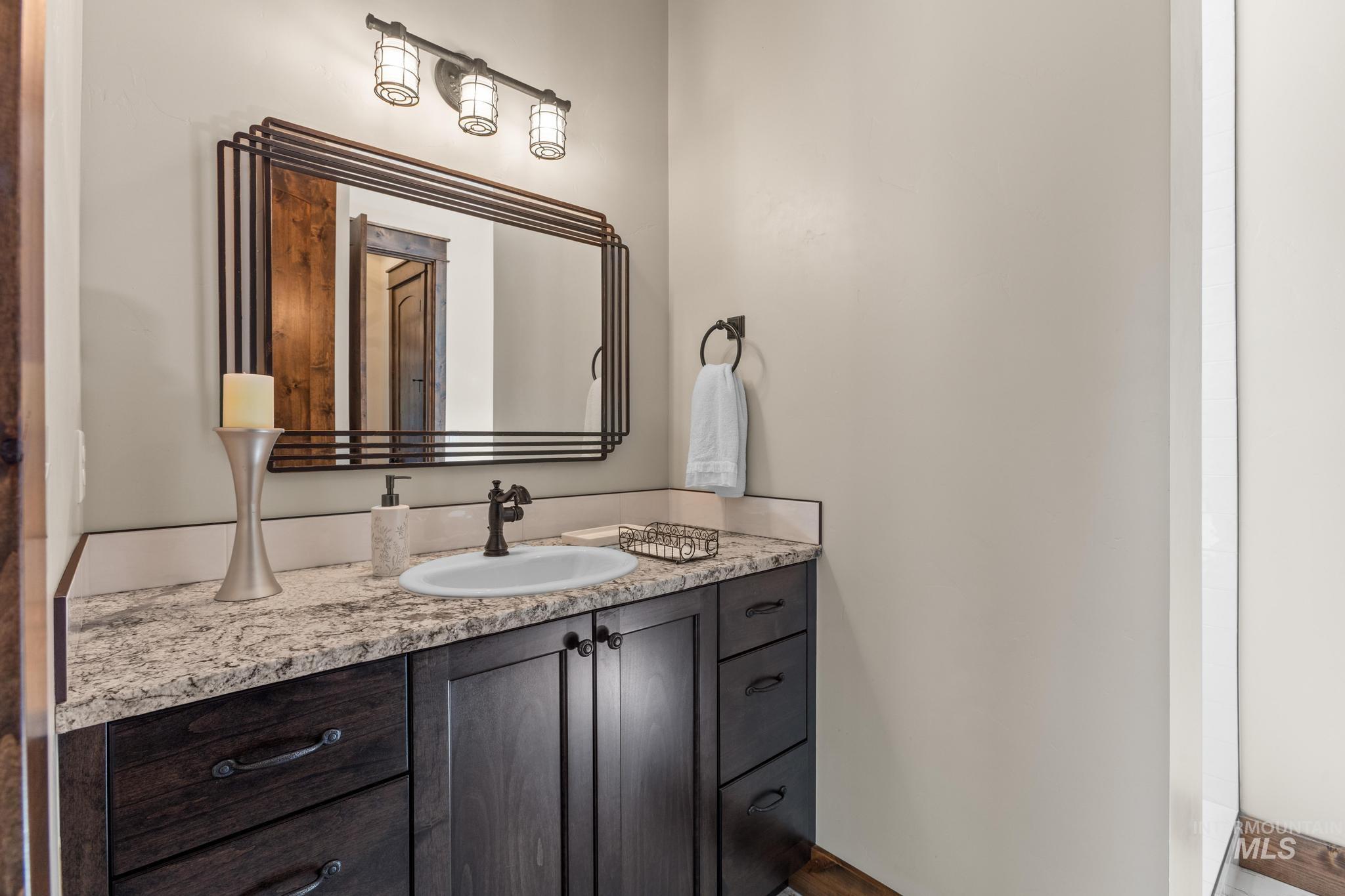 Bathroom with vanity and baseboards