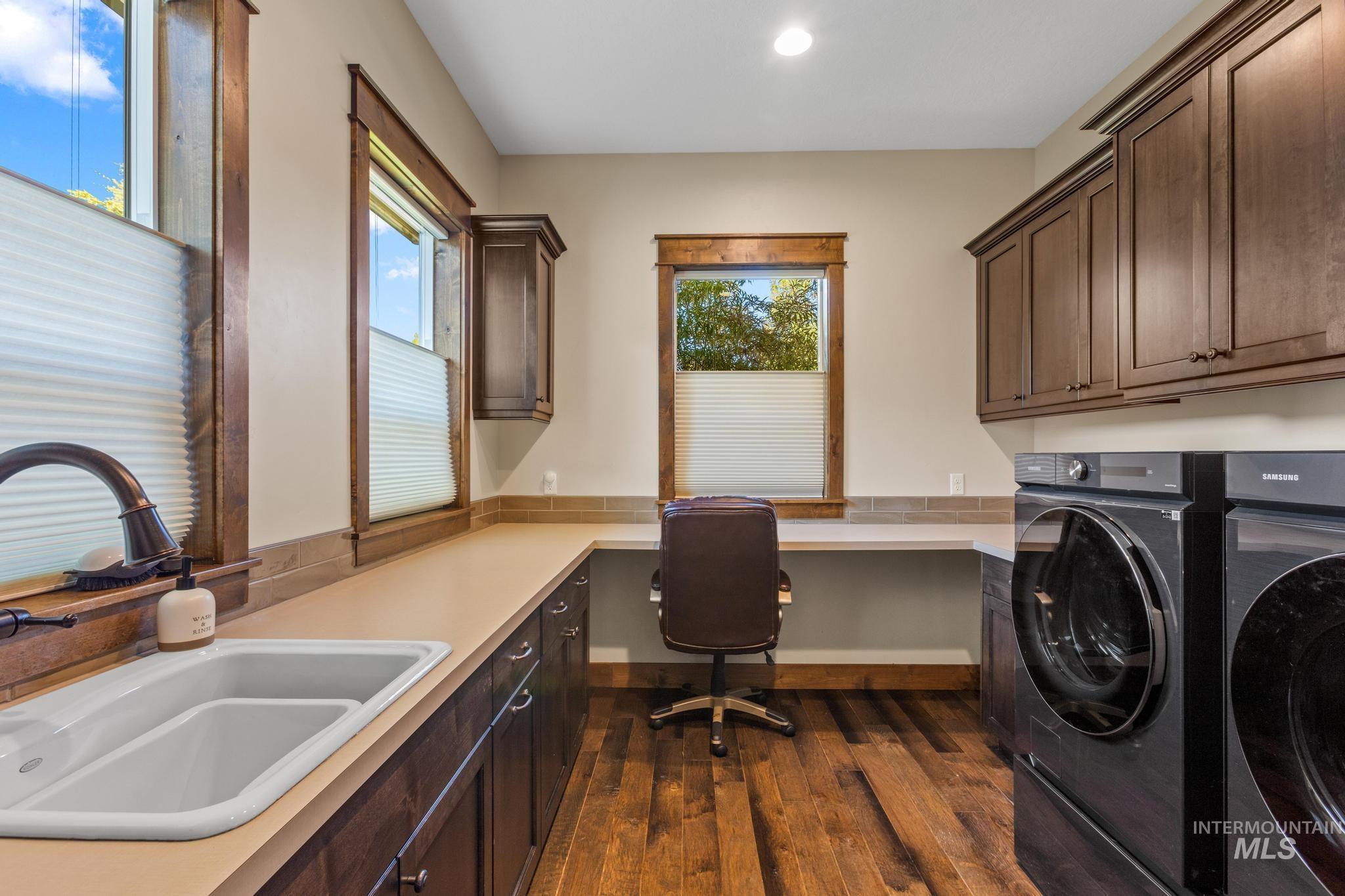 Laundry area with cabinet space, washer and clothes dryer, dark wood-style flooring, recessed lighting, and an office area