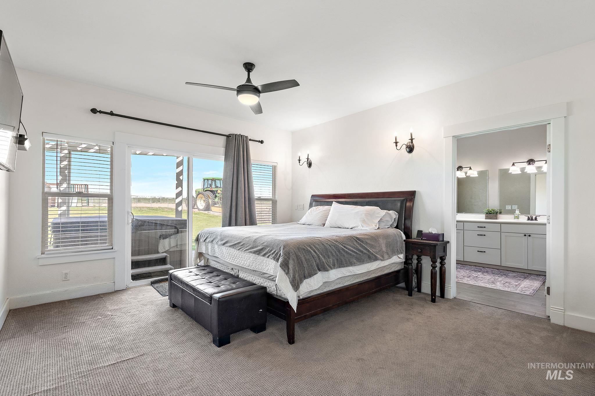 Master bedroom with glass doors that walk out to hot tub and patio.