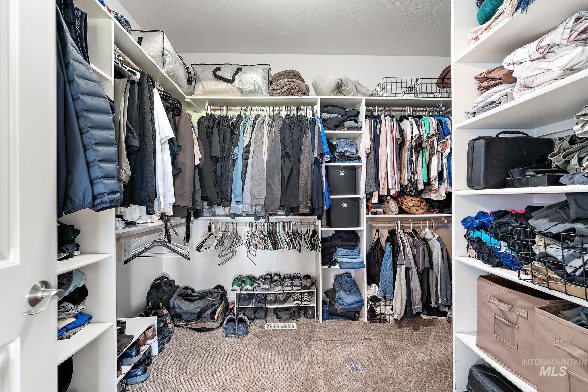 Spacious closet with carpet floors