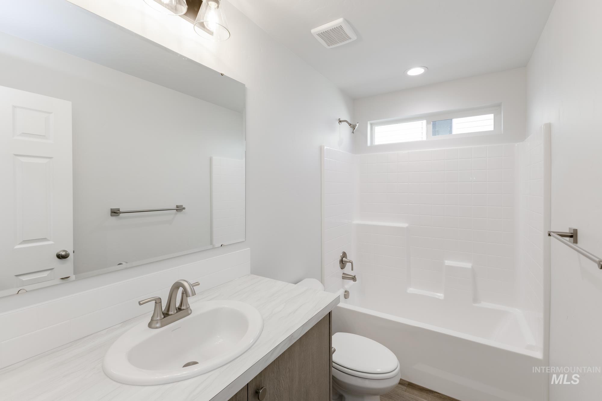 Bathroom featuring shower / washtub combination and vanity