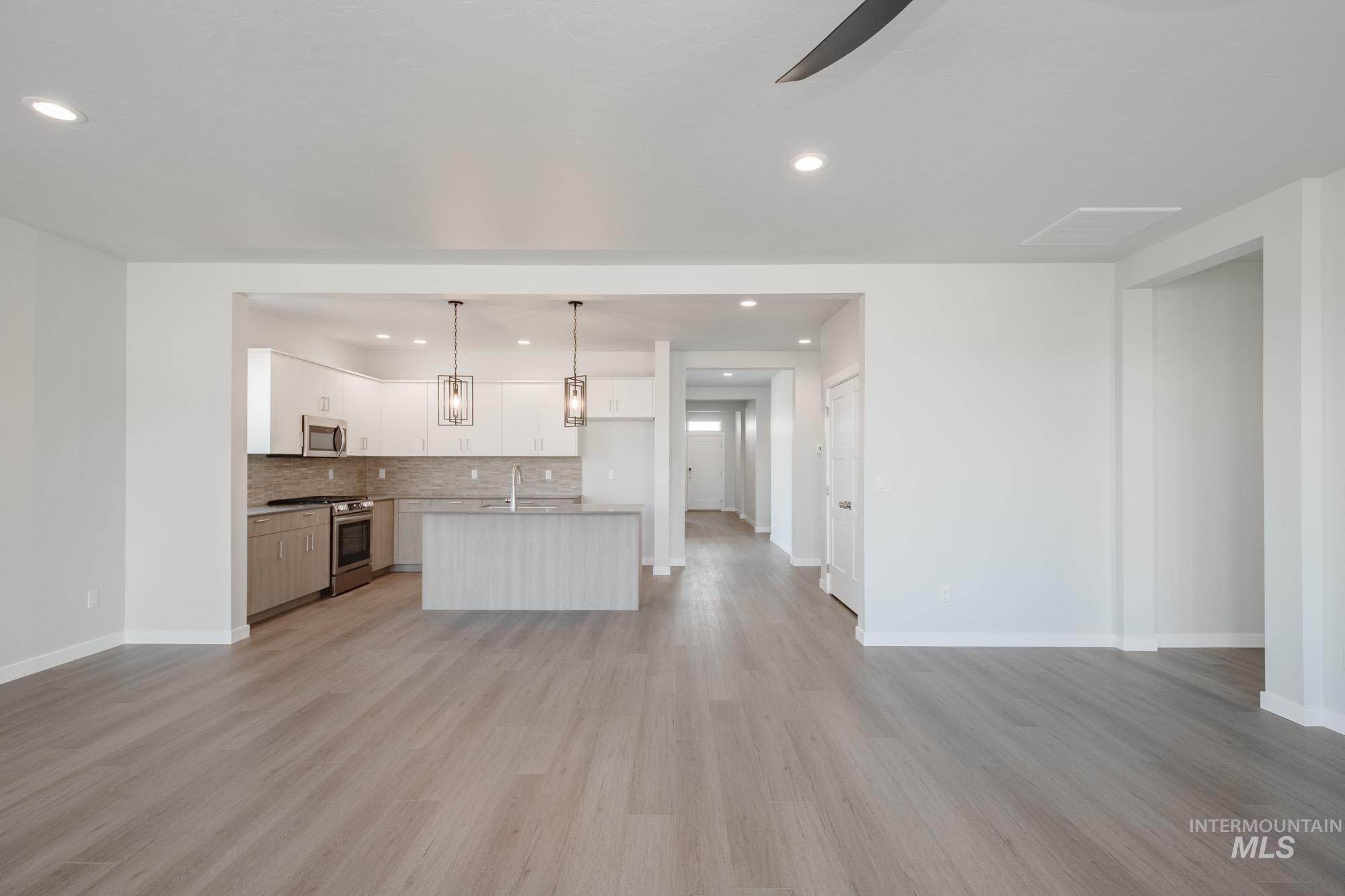 Unfurnished living room featuring recessed lighting, light wood-type flooring, and ceiling fan