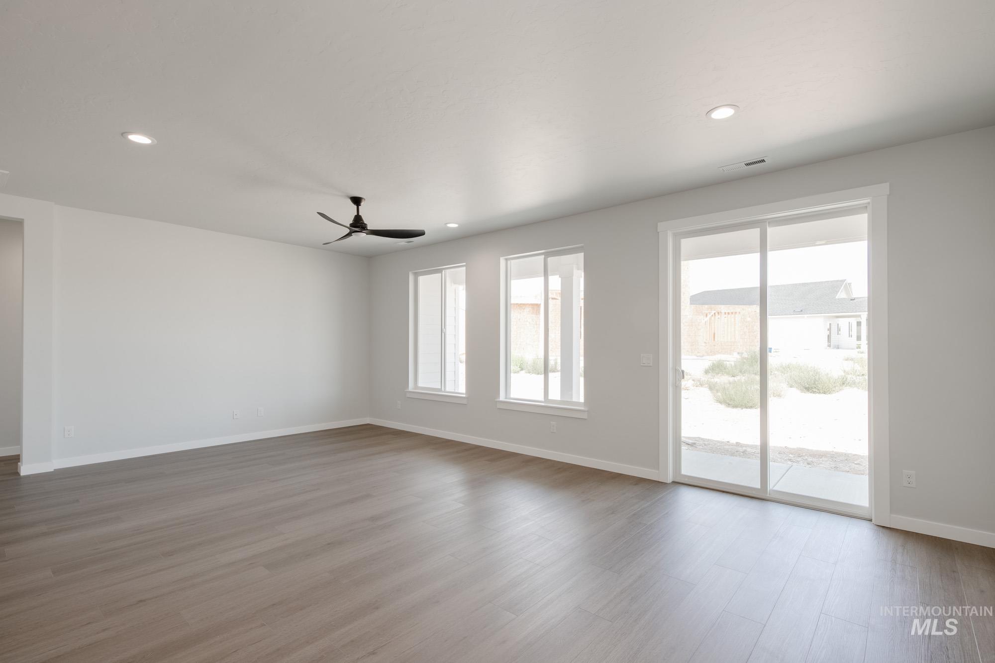 Unfurnished room with wood finished floors, recessed lighting, and a ceiling fan