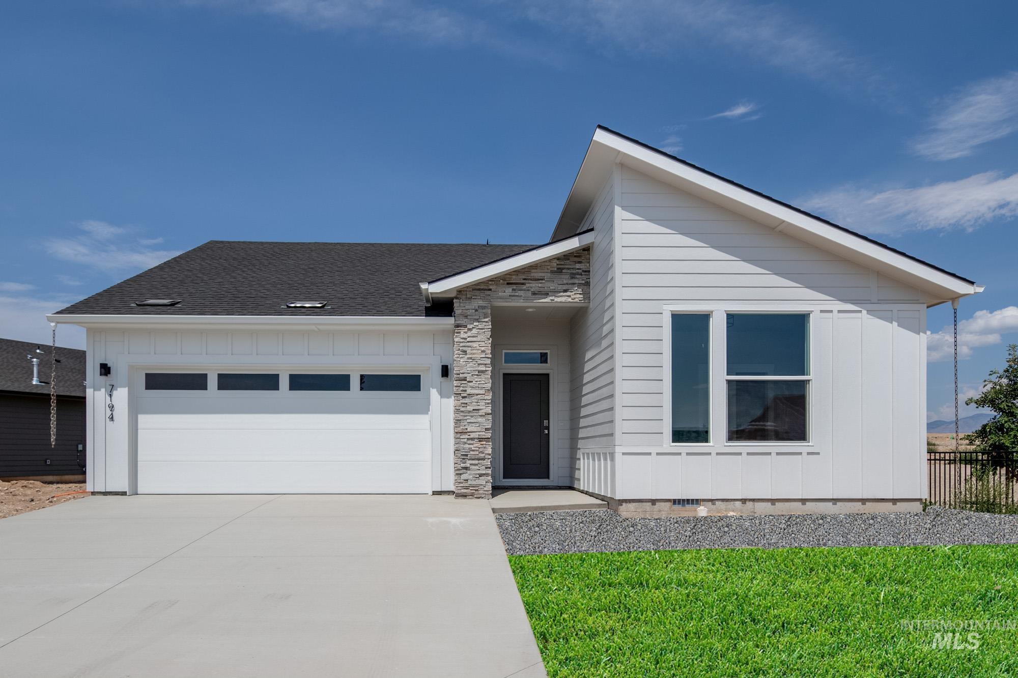 View of front facade with a garage, concrete driveway, crawl space, a shingled roof, and stone siding
