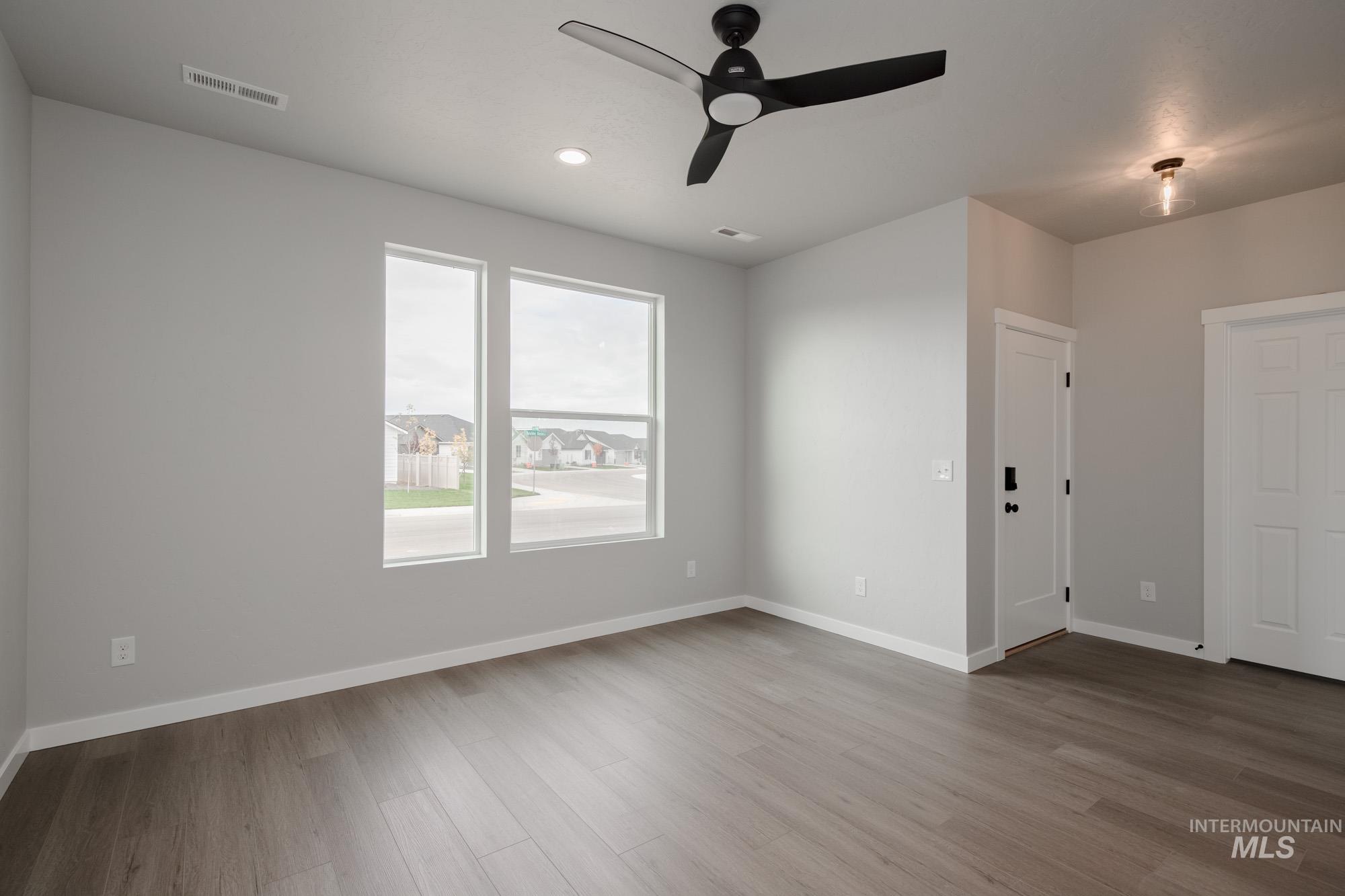 Empty room featuring light wood-style flooring, a ceiling fan, and recessed lighting