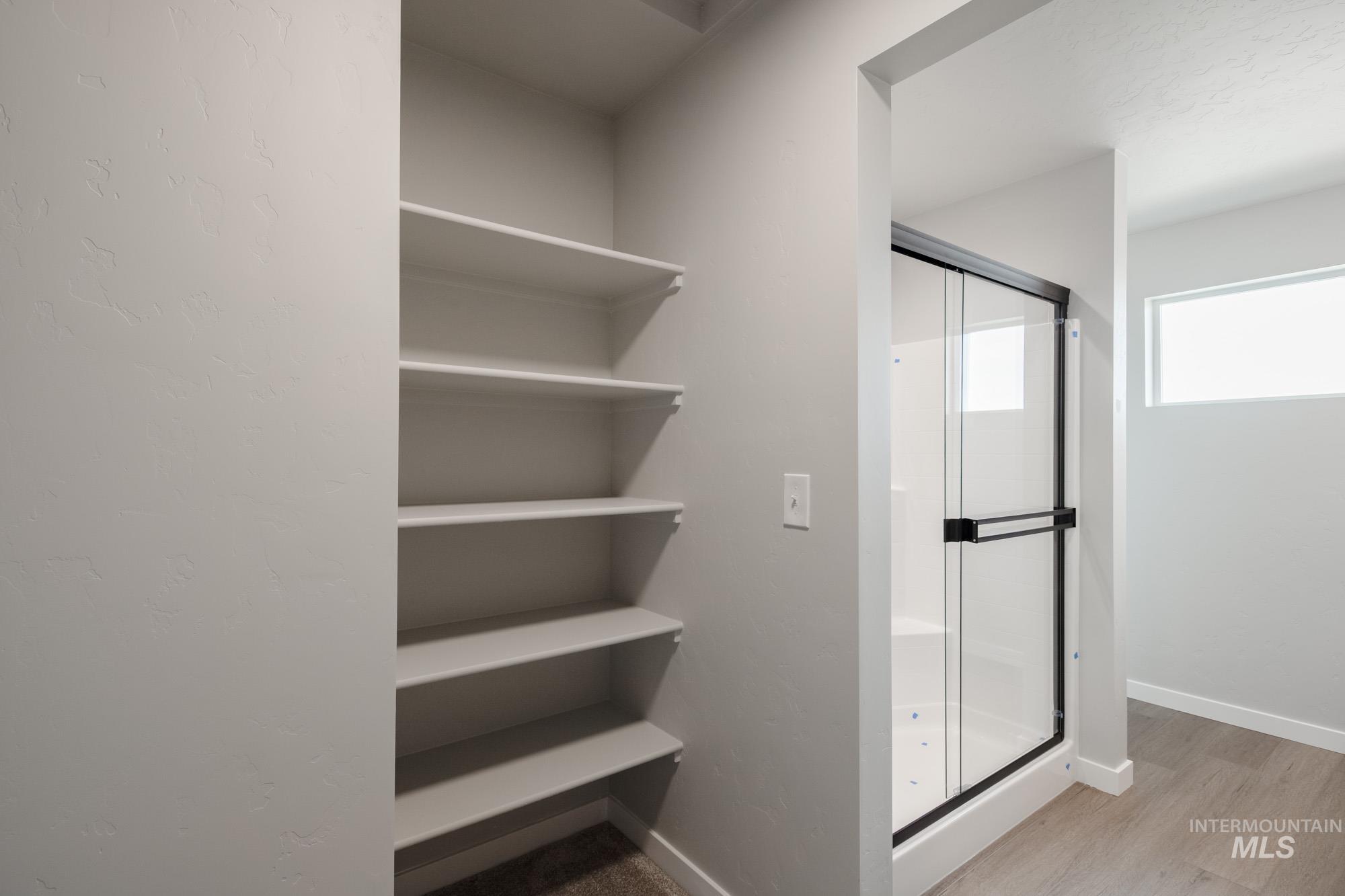 Bathroom featuring a stall shower and light wood-type flooring