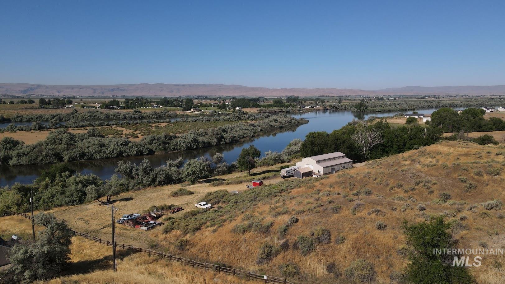 Aerial view of property's location featuring a water and mountain view