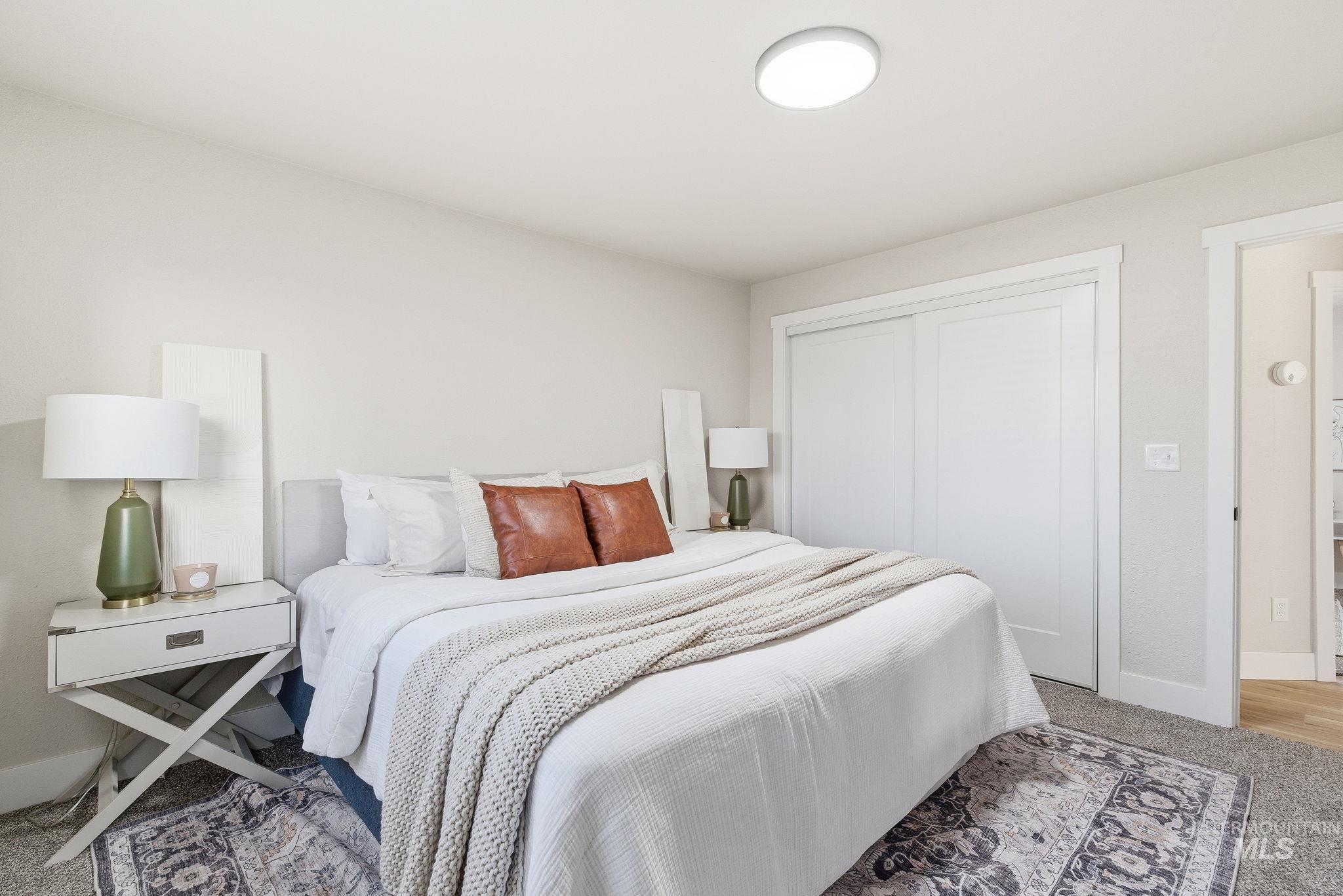 Bedroom featuring light colored carpet and a closet