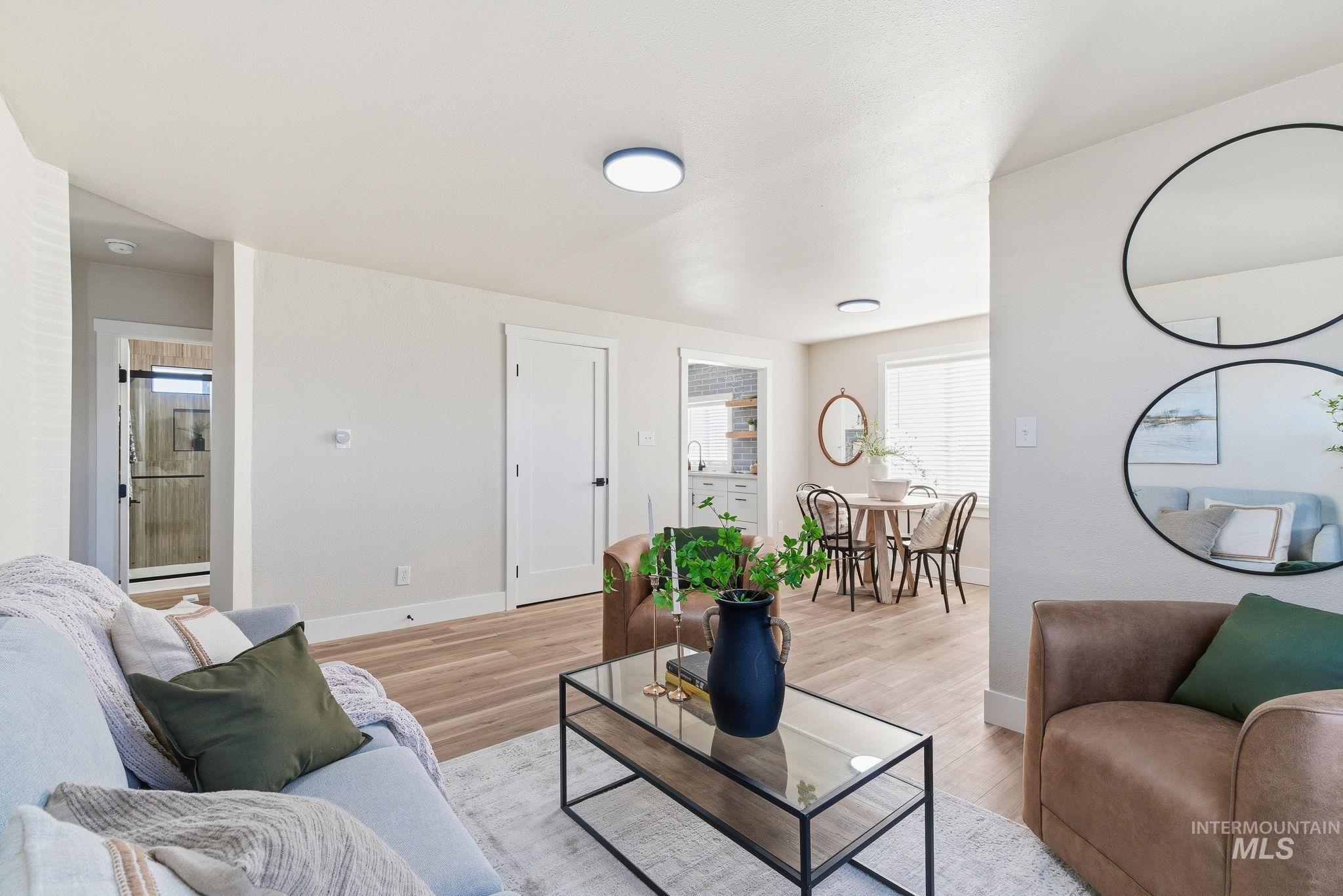 Living room with light wood-type flooring and baseboards