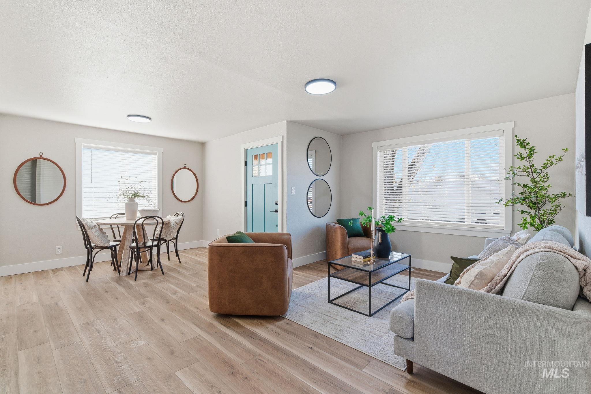 Living room featuring light wood-style floors and baseboards