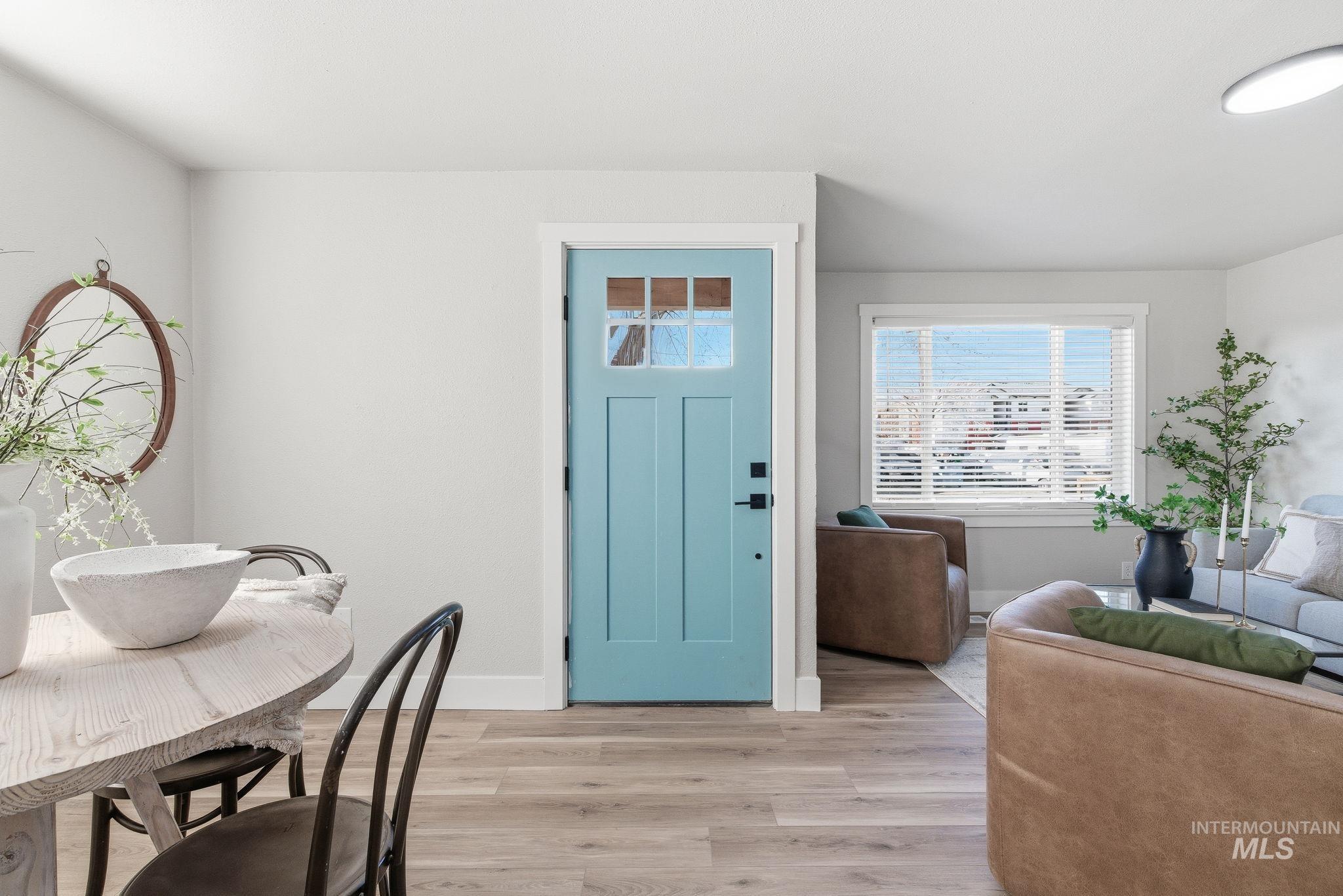 Foyer with light wood finished floors and baseboards