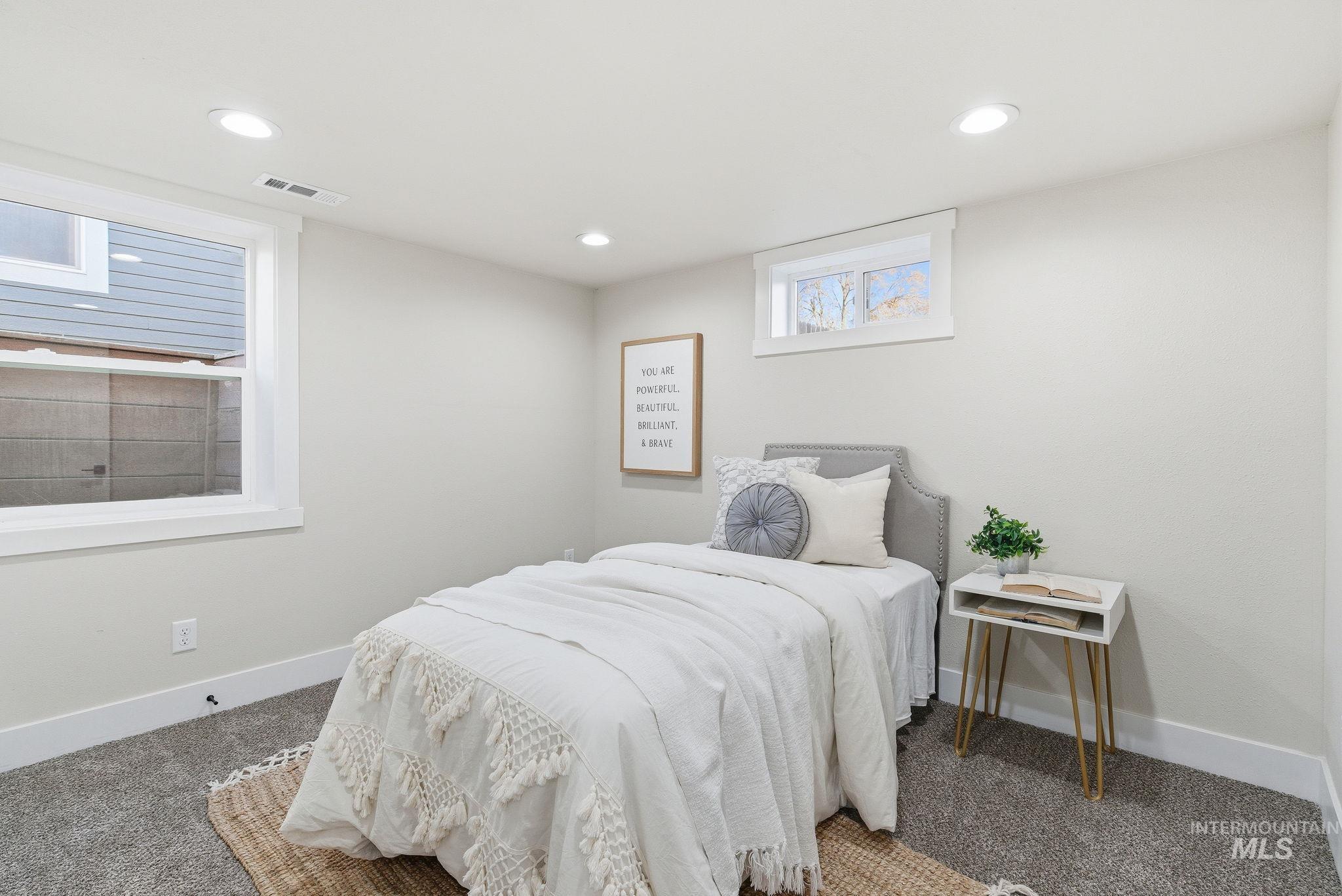 Carpeted bedroom with baseboards and recessed lighting