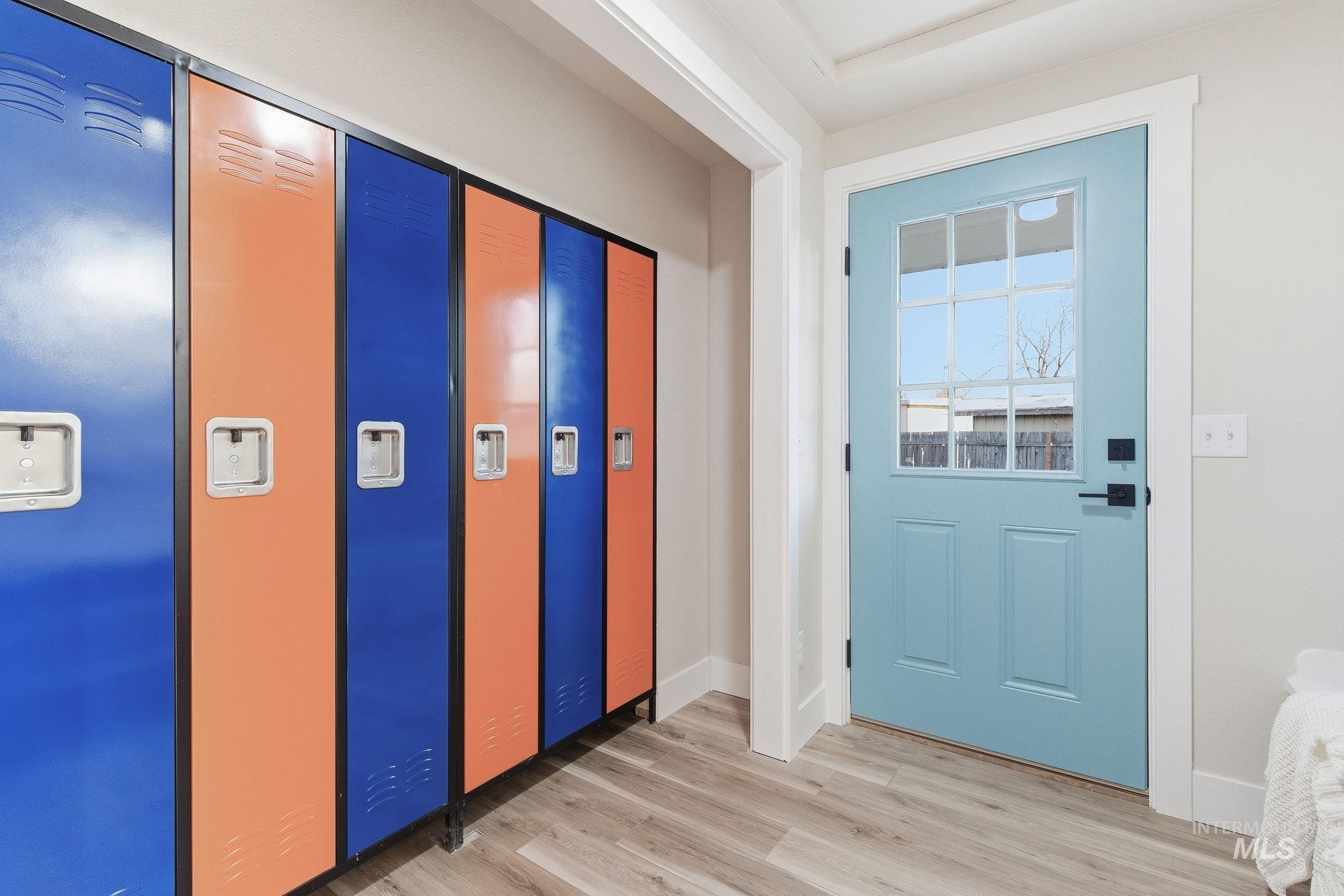 Doorway featuring wood finished floors and baseboards