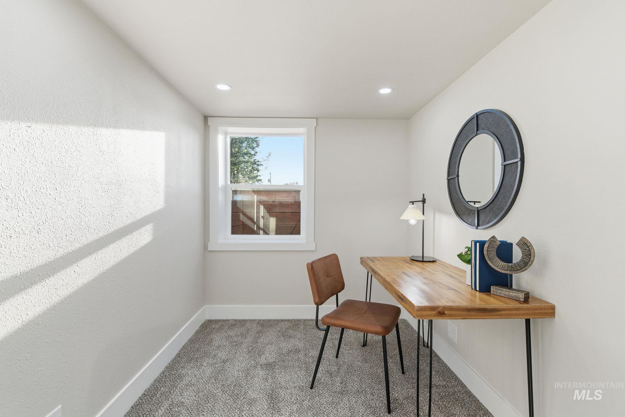 Office featuring light colored carpet and recessed lighting