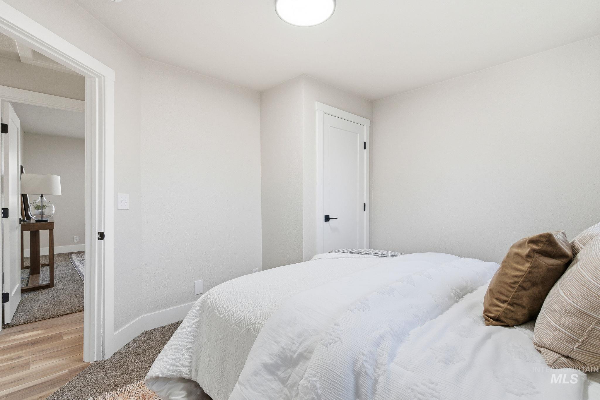 Bedroom featuring baseboards and light colored carpet