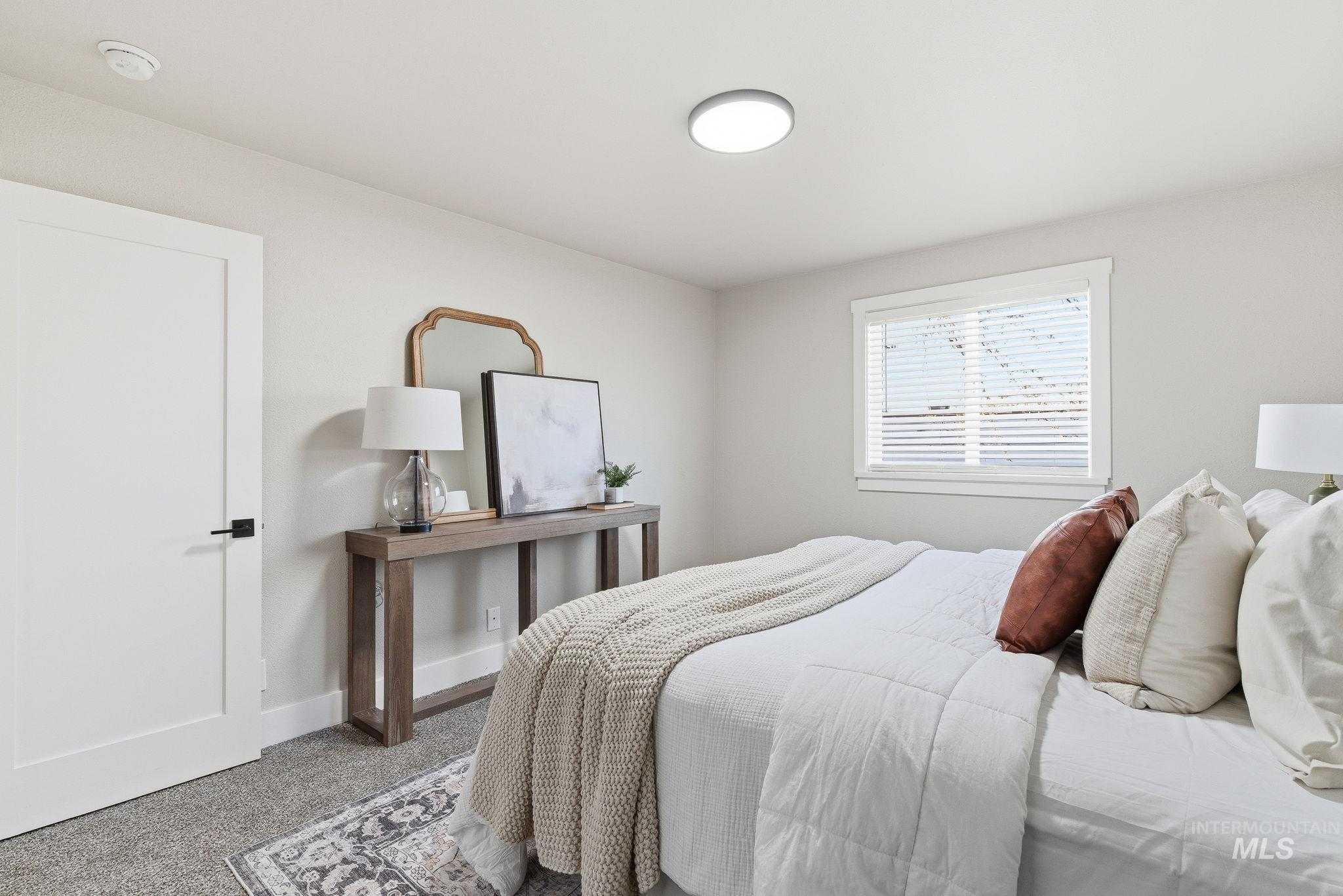 Bedroom with carpet flooring and baseboards