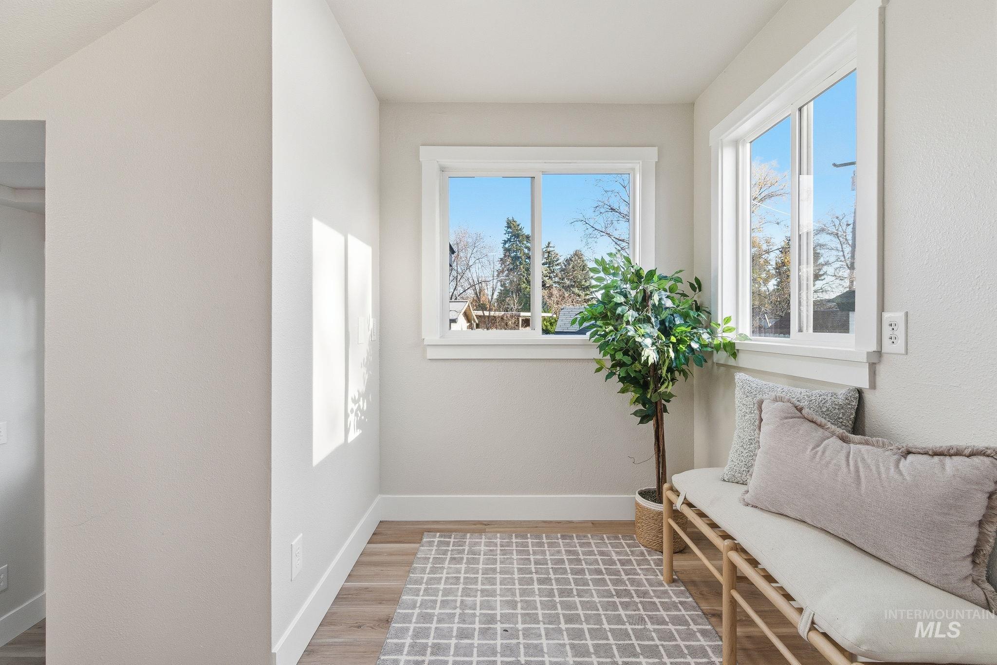 Sitting room with healthy amount of natural light and light wood-type flooring