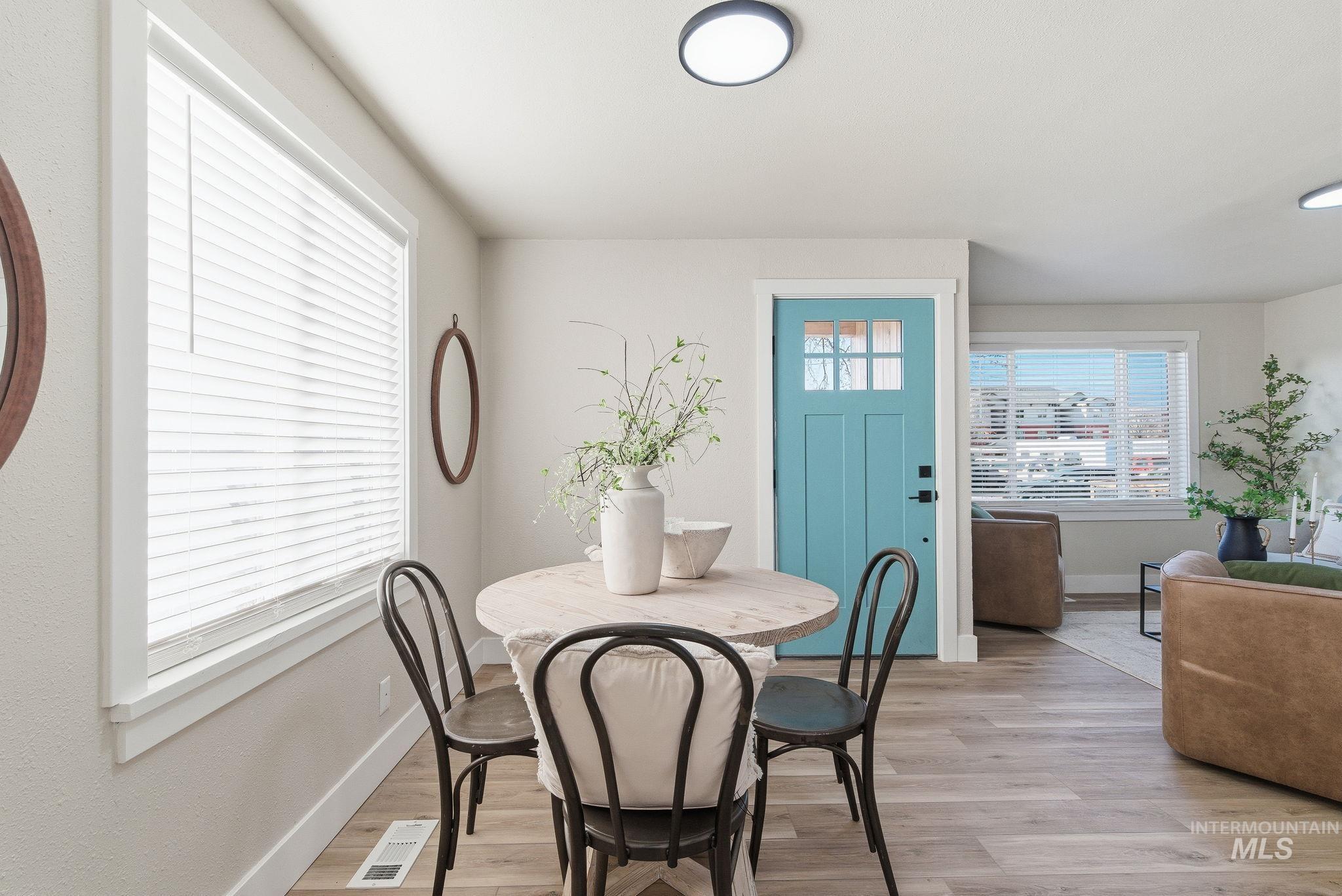 Dining space featuring light wood-style flooring and baseboards
