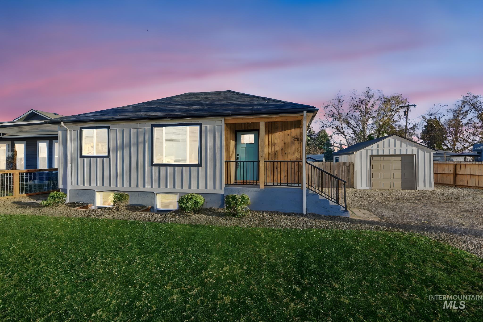 View of front of house with an outbuilding and covered porch