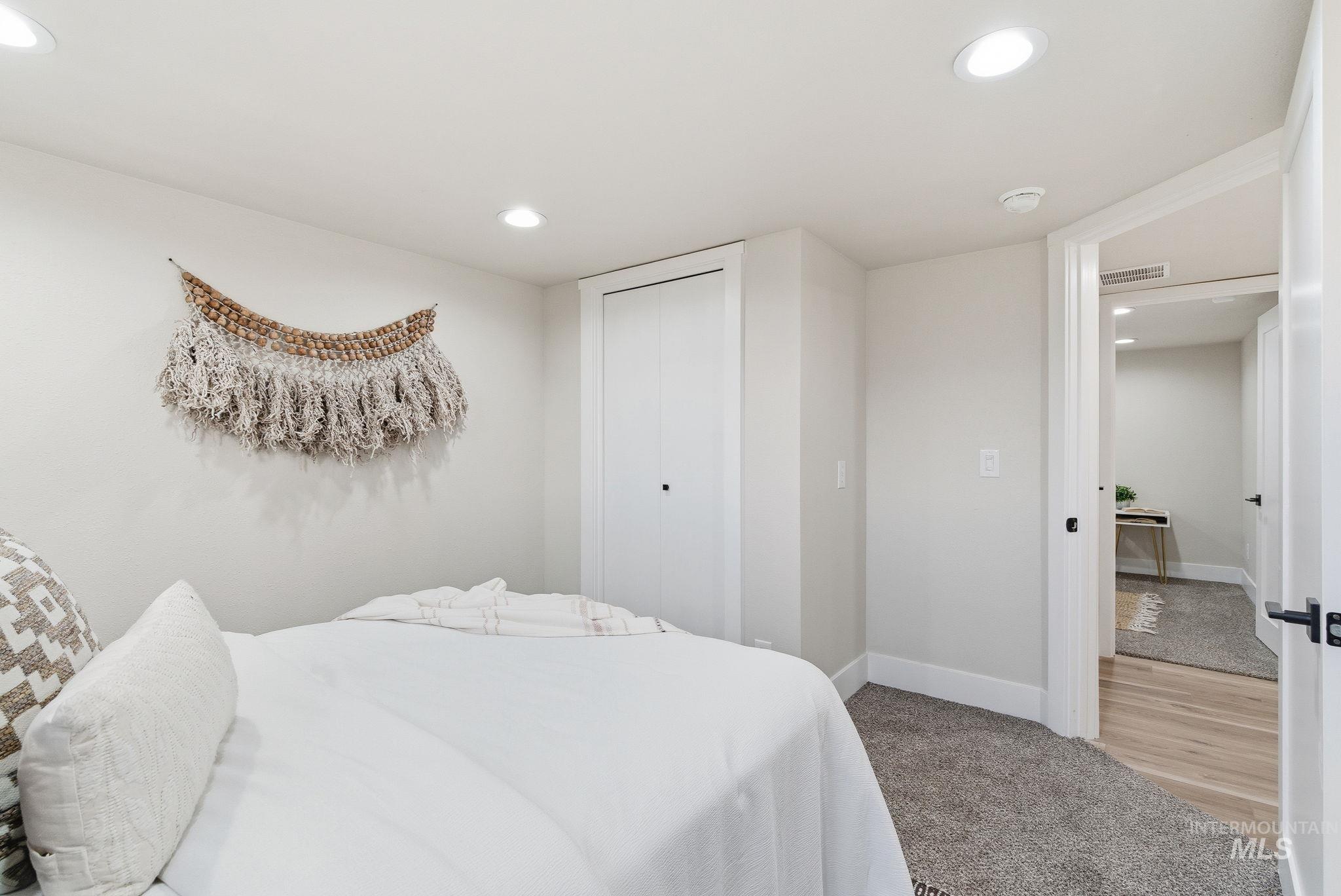 Bedroom featuring recessed lighting, a closet, and light carpet
