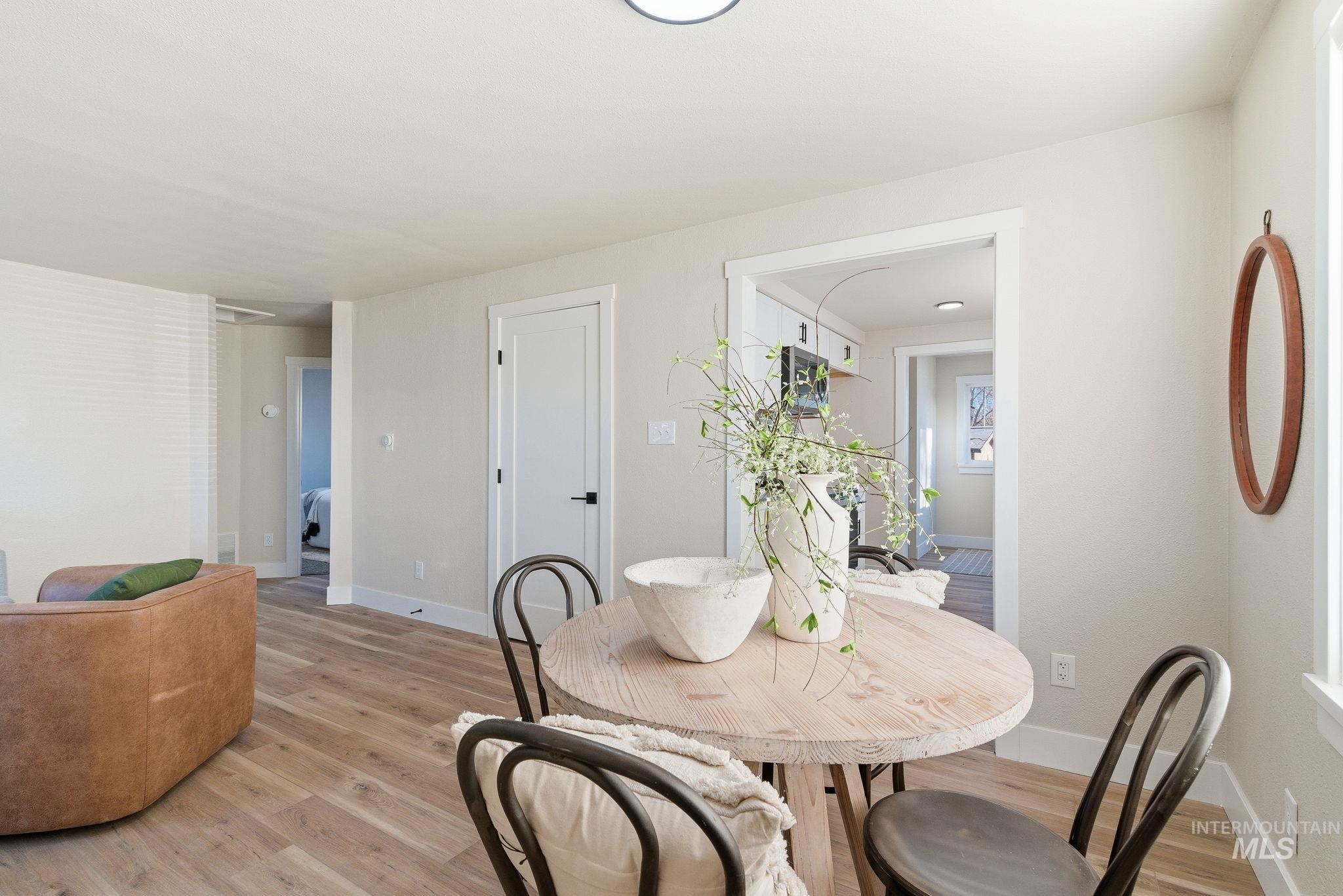 Dining space with light wood-type flooring and baseboards
