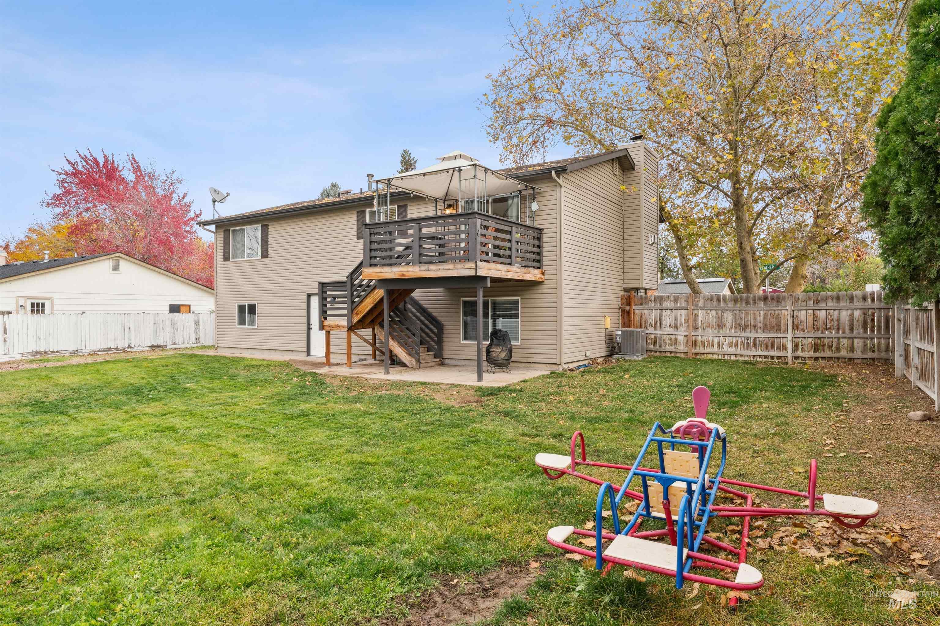 Rear view of property with a patio, a fenced backyard, stairway, and a wooden deck