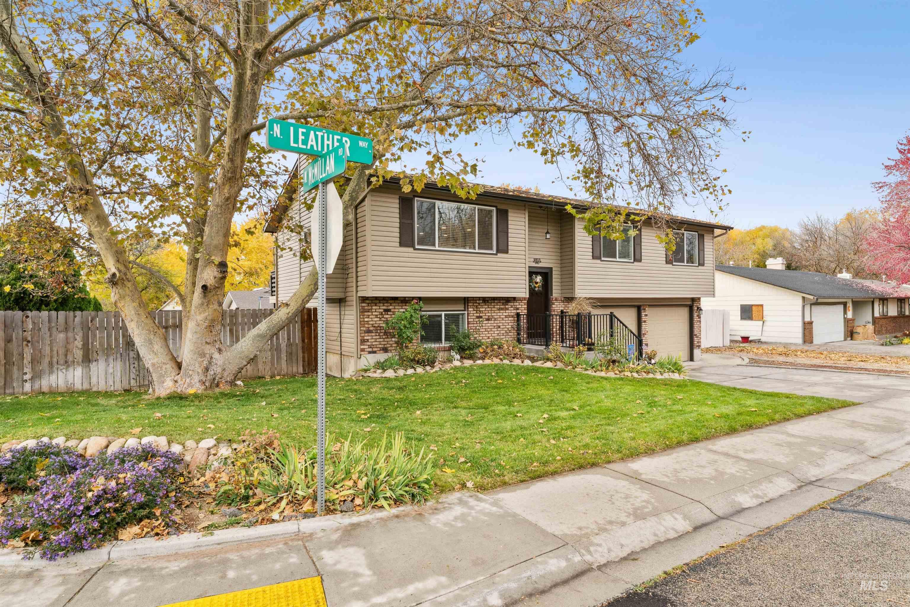 Split foyer home featuring brick siding, concrete driveway, and a garage