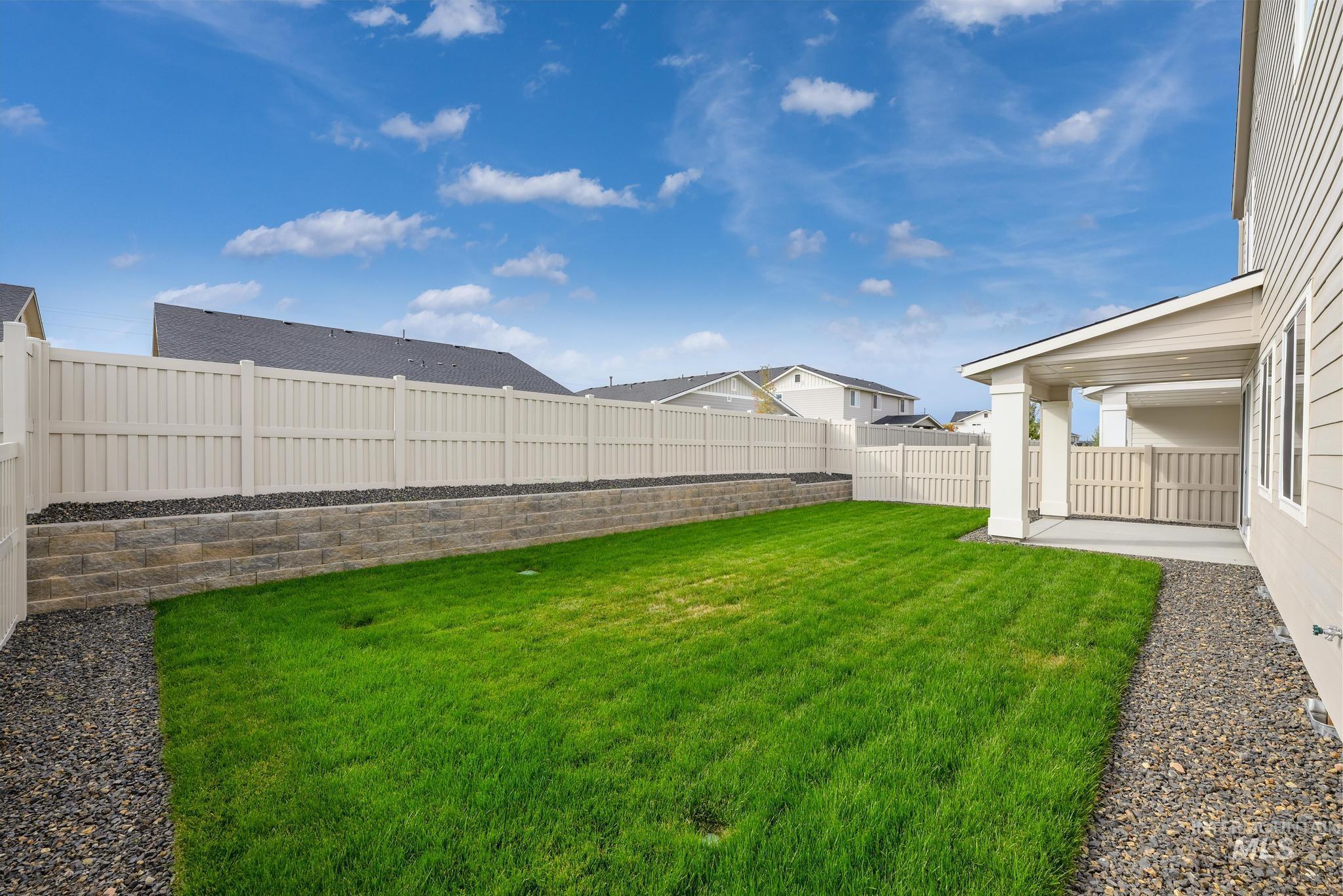 Fenced backyard with a patio and a residential view