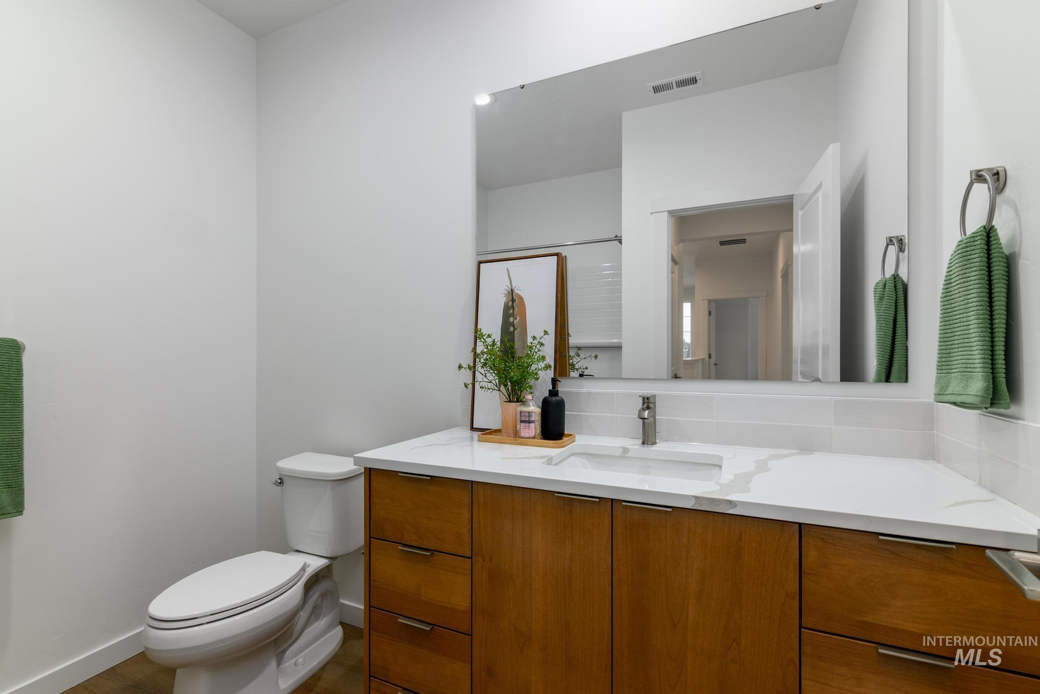 Full bathroom featuring vanity and a shower stall