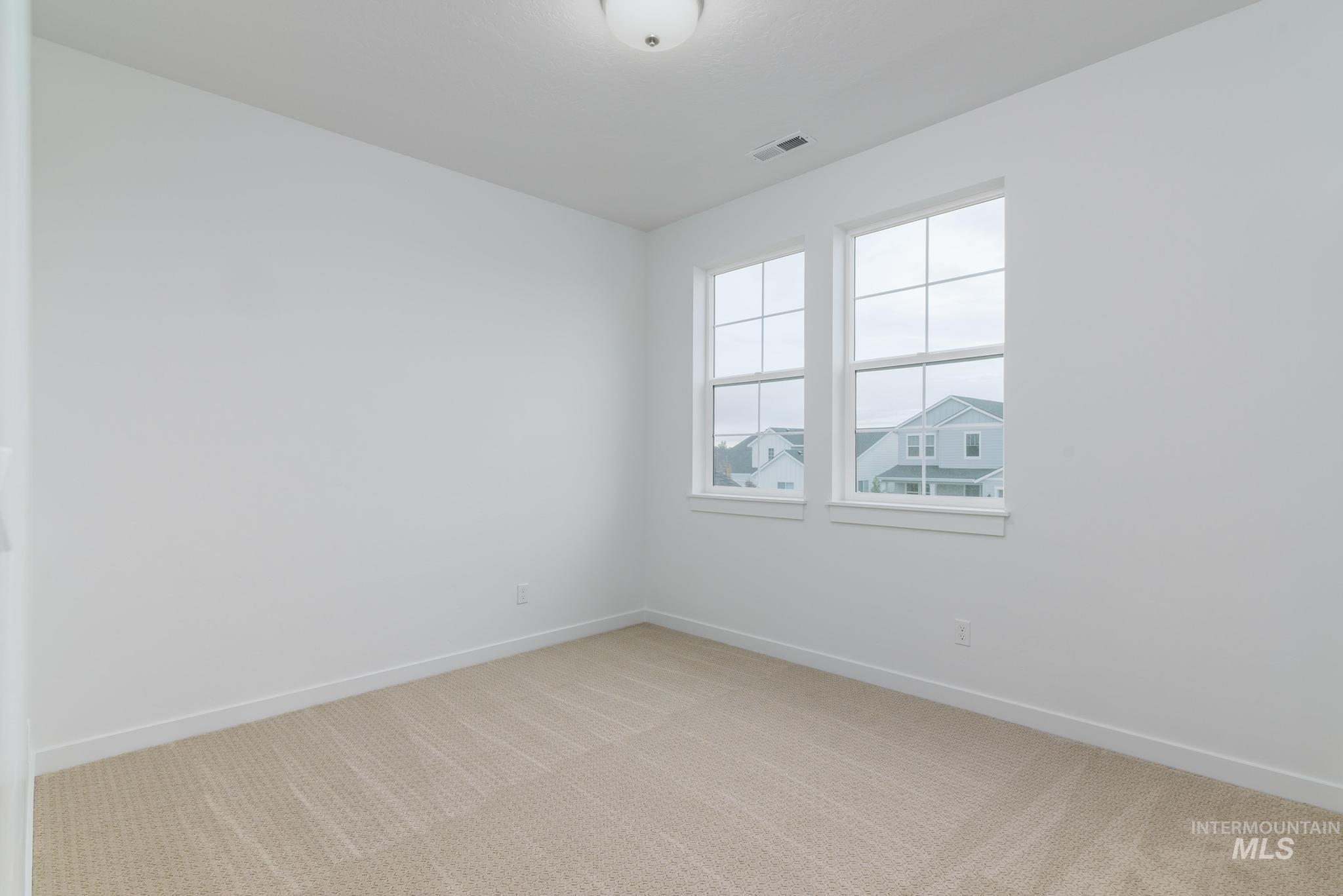 Unfurnished room with carpet floors and baseboards