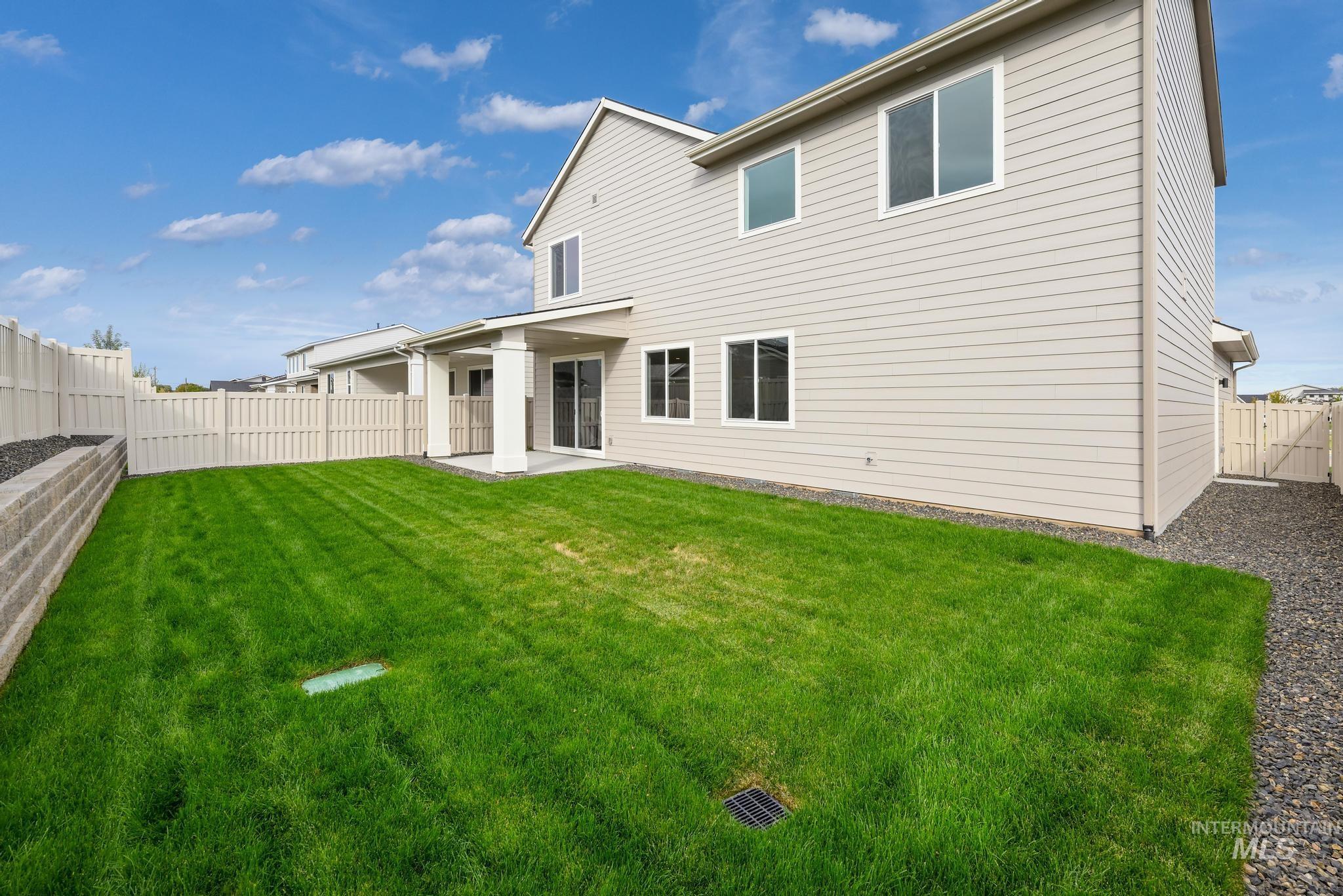 Rear view of property with a patio and a fenced backyard
