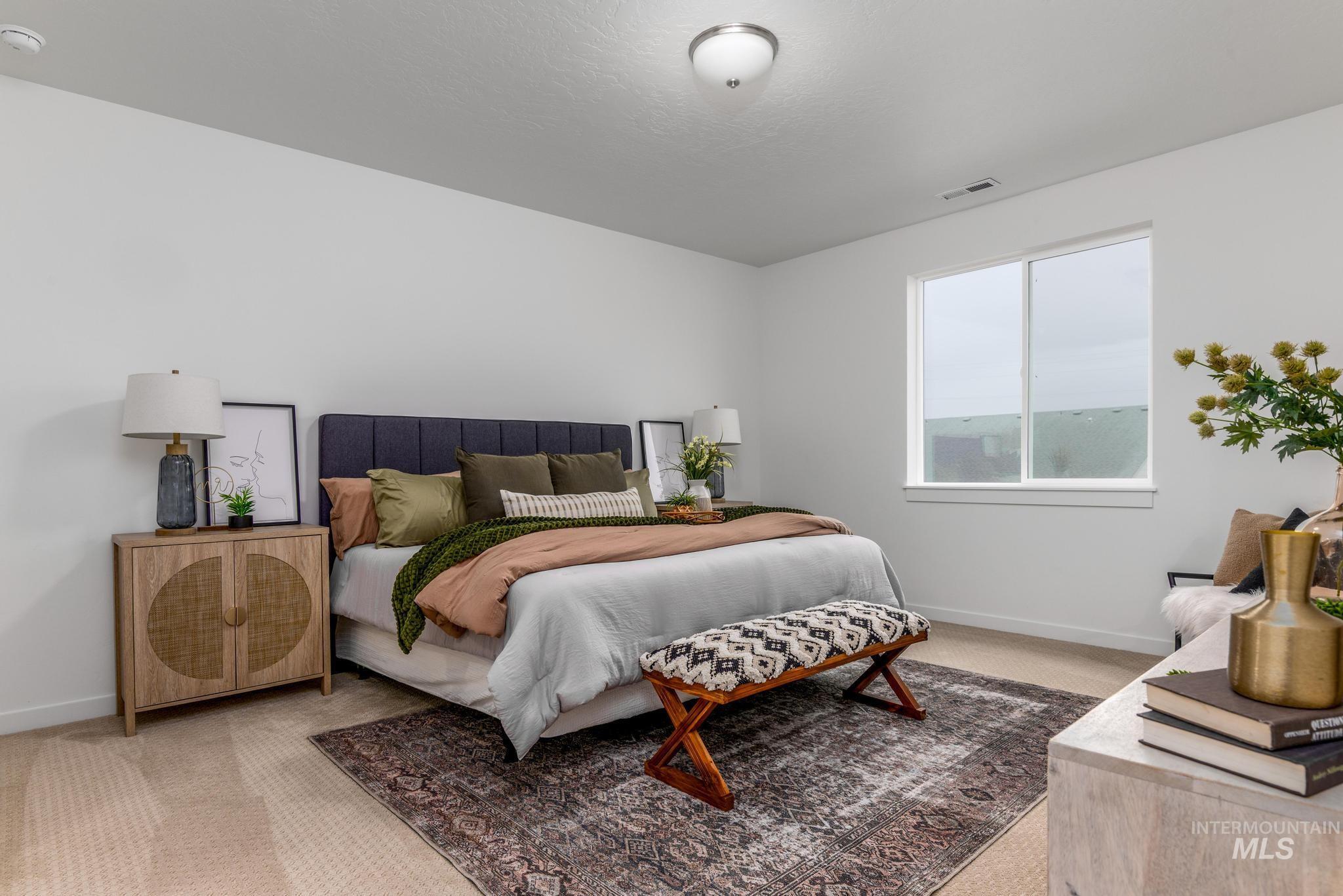 Bedroom with light carpet and baseboards