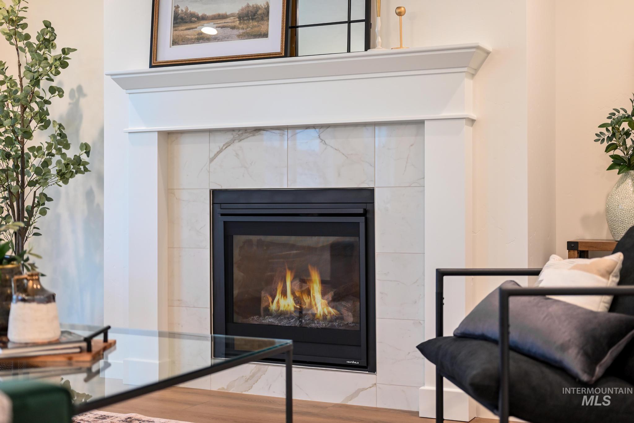 Detailed view of a tiled fireplace and wood finished floors