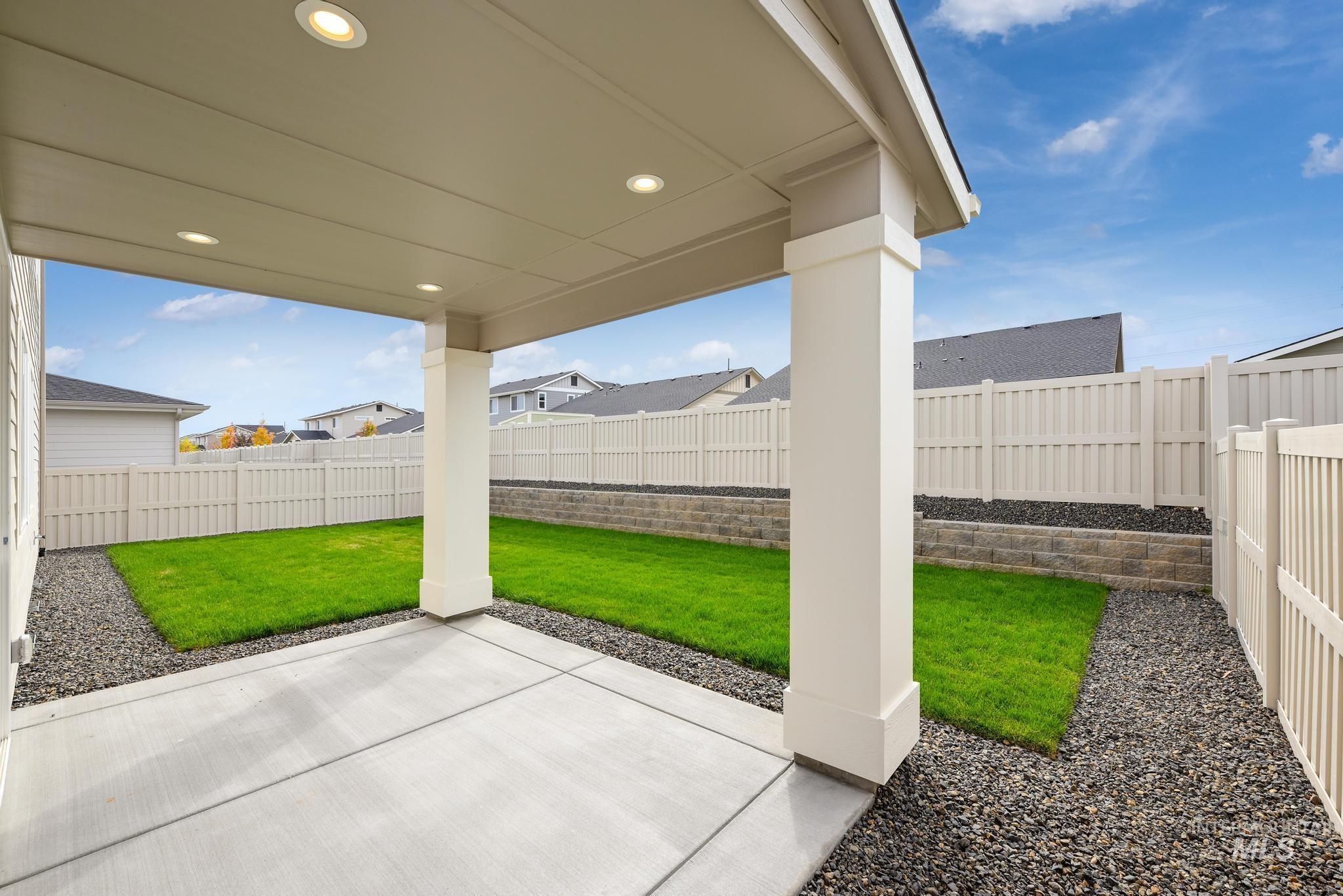 Fenced backyard with a patio and a residential view