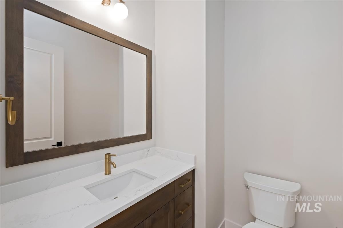 Half bathroom with vanity and toilet