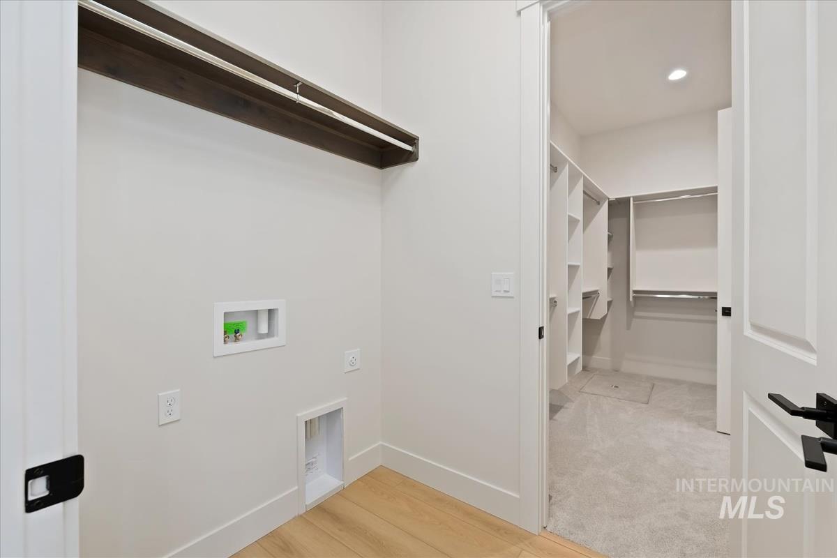 Laundry area featuring washer hookup, light wood-style flooring, and recessed lighting