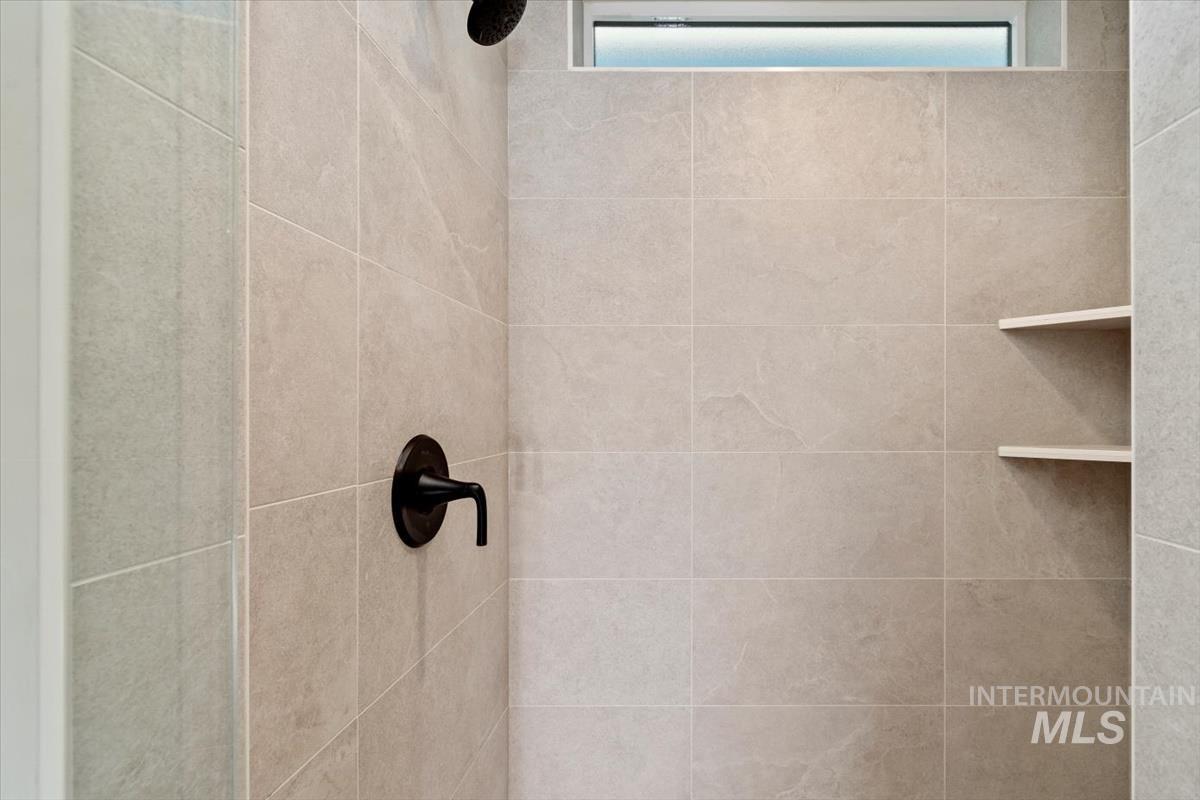 Bathroom view of a tile shower