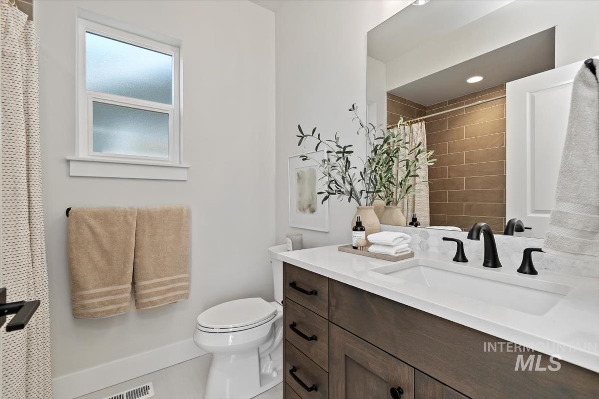 Bathroom featuring vanity and a shower with shower curtain