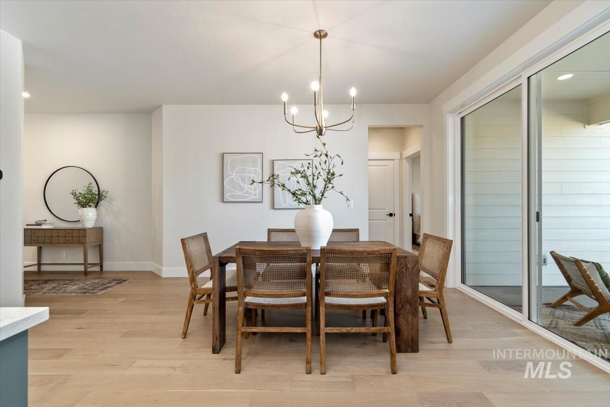 Dining space featuring light wood-style flooring, a chandelier, and recessed lighting