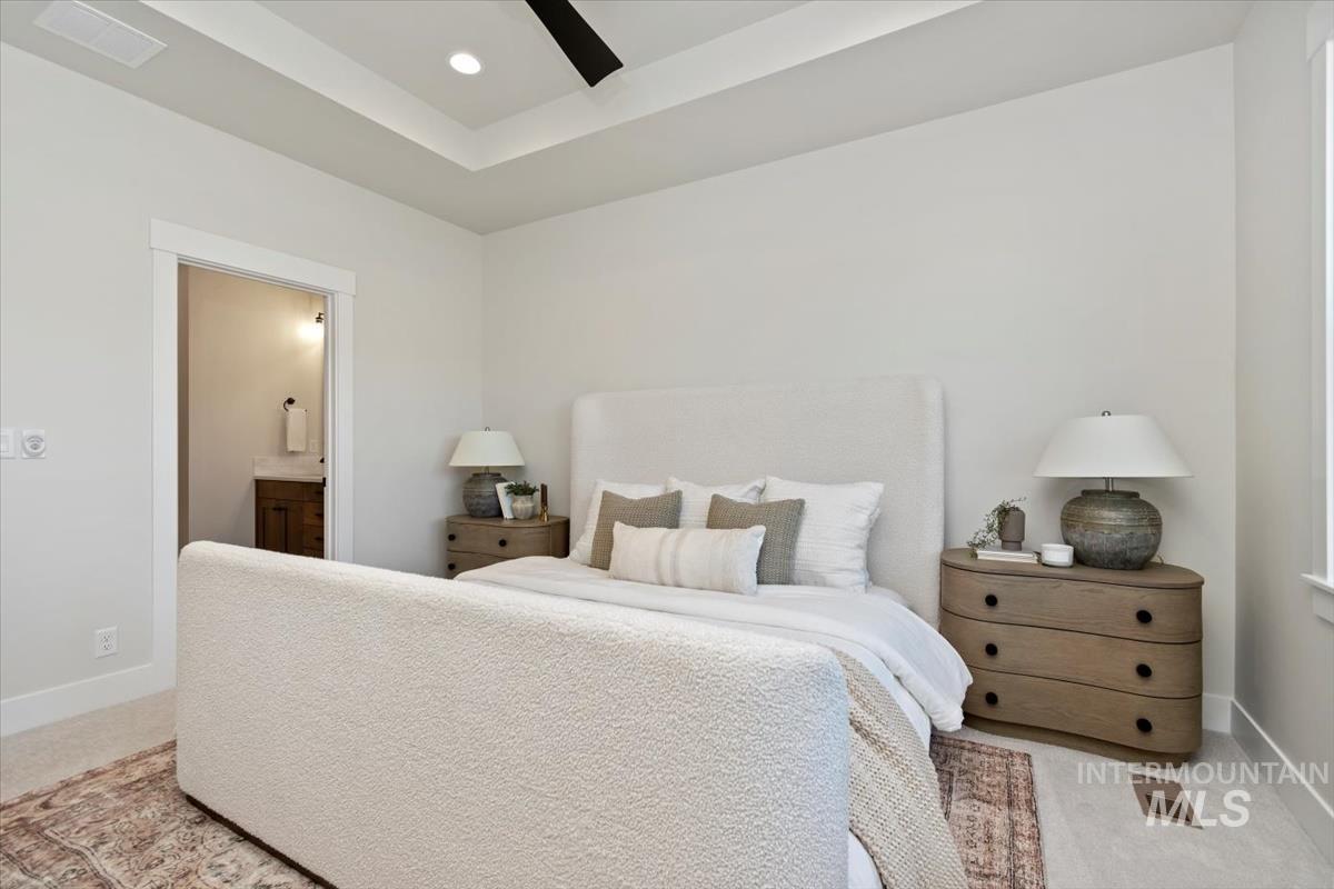 Carpeted bedroom featuring ensuite bathroom, ceiling fan, and recessed lighting