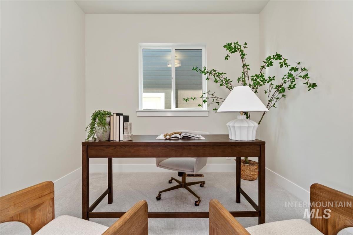 Office area featuring baseboards and carpet flooring