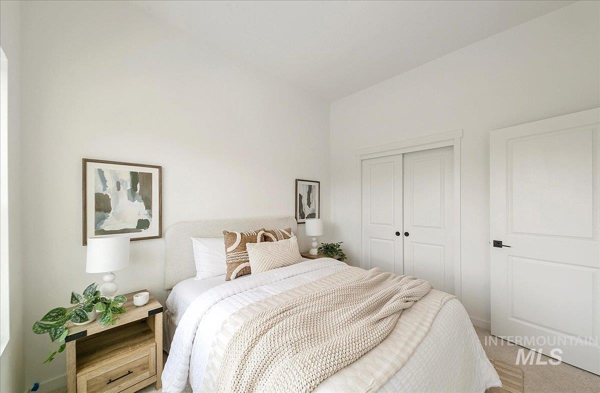 Bedroom featuring a closet and light carpet