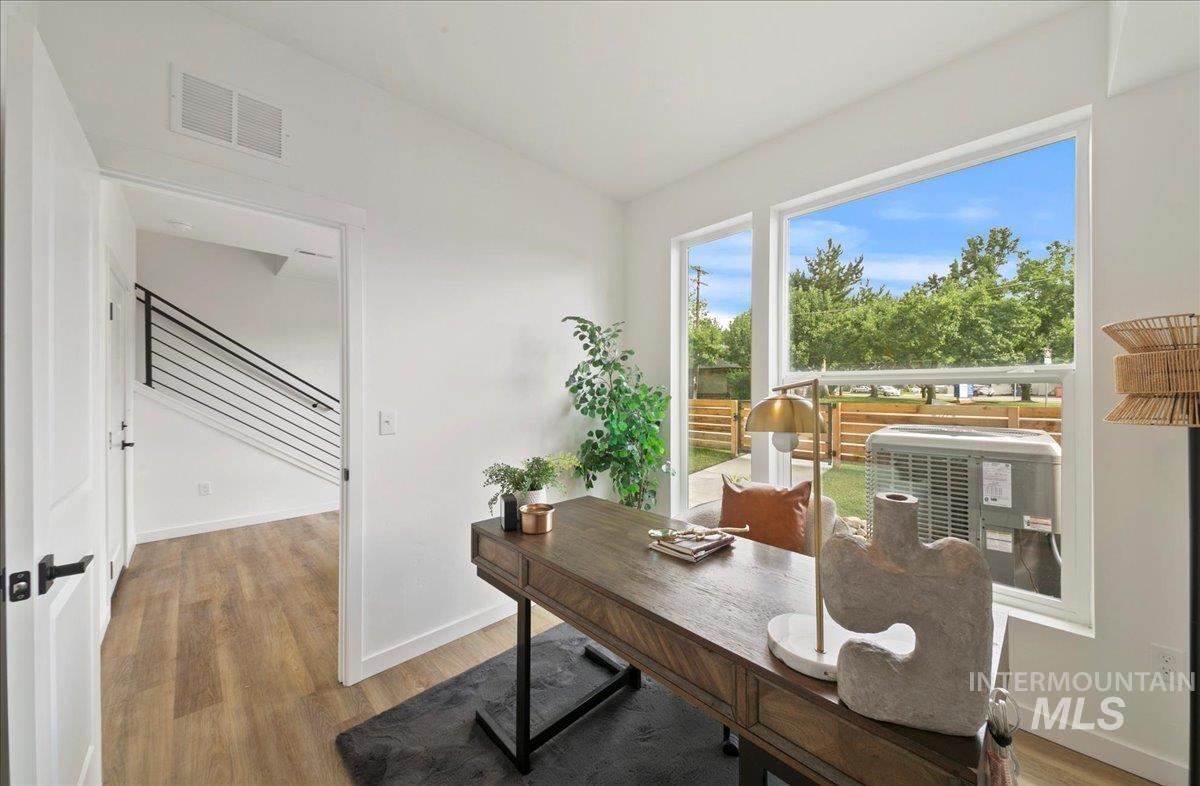 Office space with light wood-style floors and baseboards