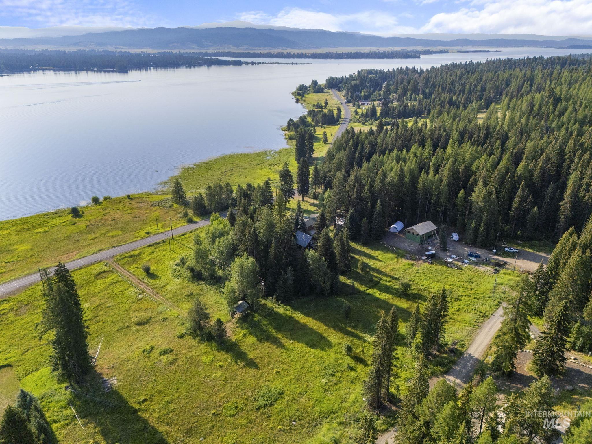 Aerial view of property's location featuring a water and mountain view