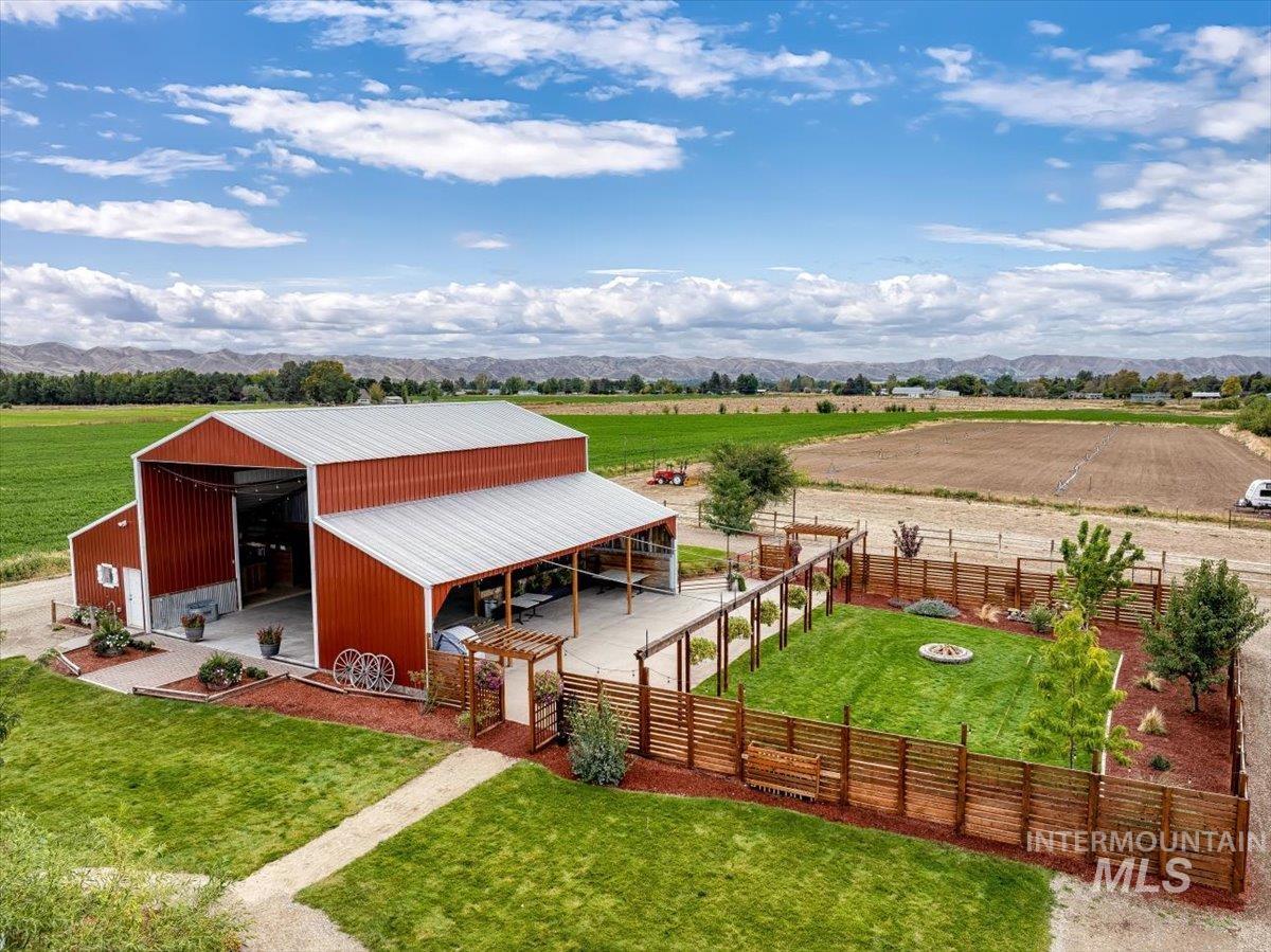 View of outdoor structure featuring a rural view, an exterior structure, a mountain view, and an outdoor fire pit